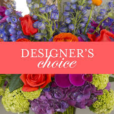 Mixed bouquet with red roses and purple flowers, labeled designer's choice