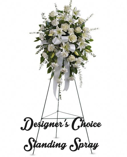 White standing floral spray on a metal easel with ribbon