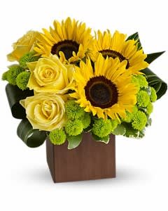 Yellow sunflowers and roses arranged in a wooden box