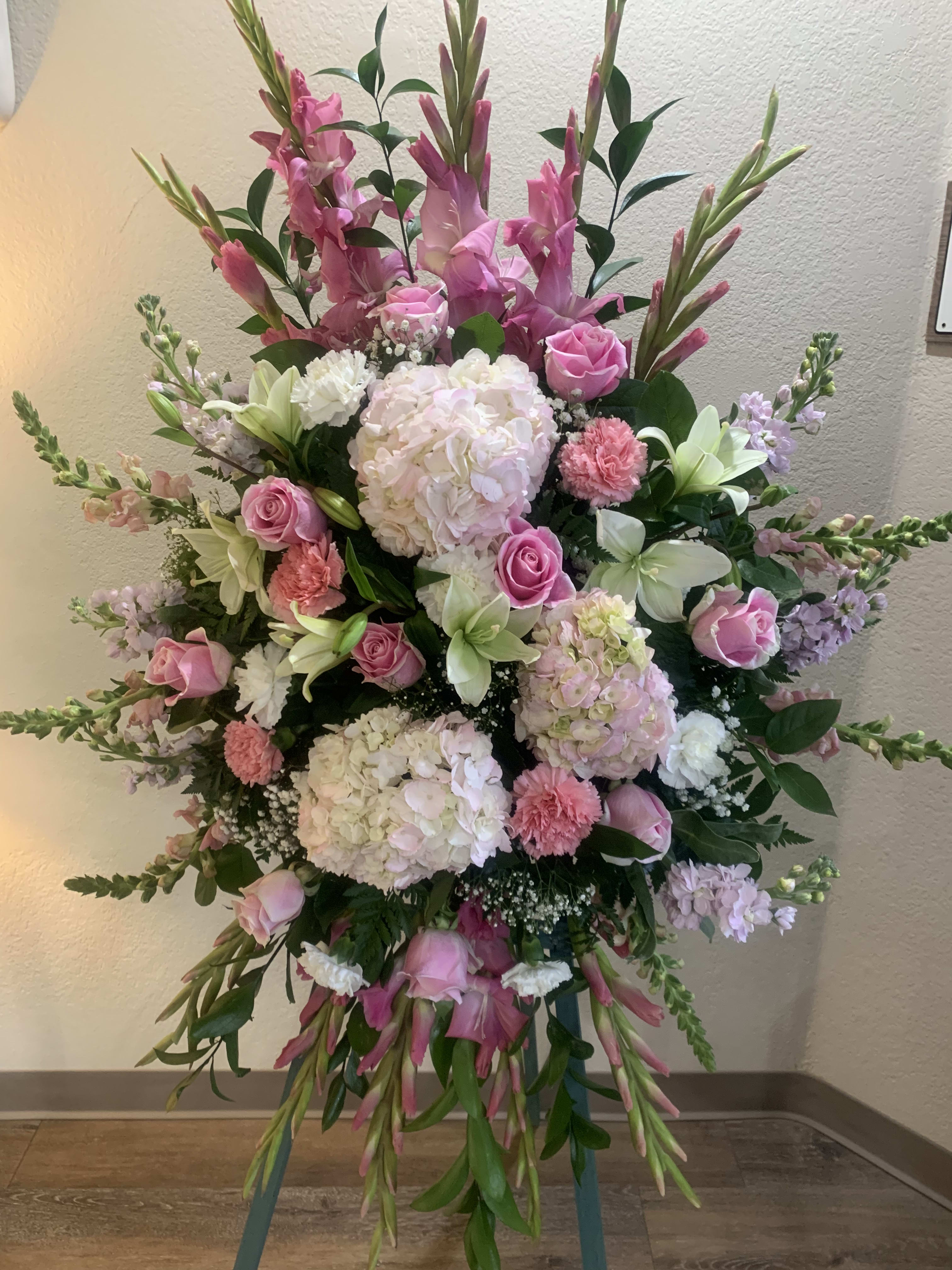 Compassion by BloomNation™  - Pink roses, lilies, and more come together for a blushing pink standing funeral spray. 