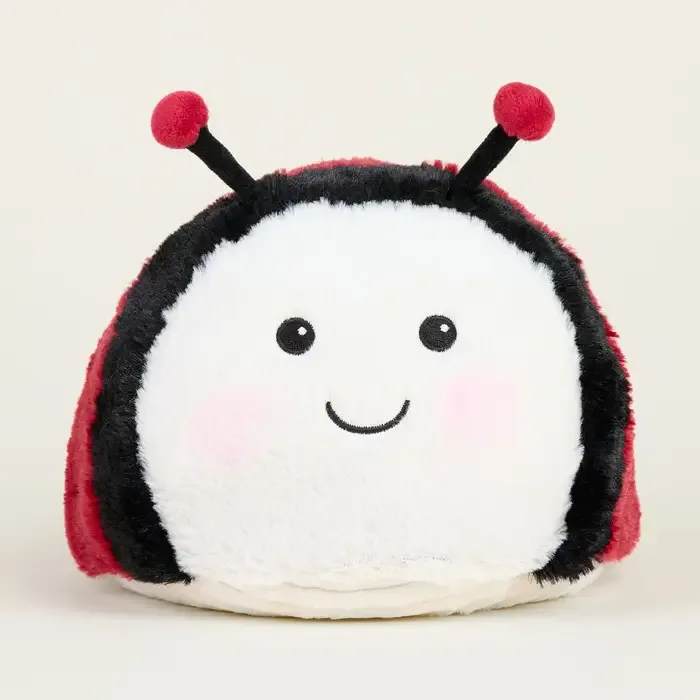 Plush ladybug toy with a smiling face and red-and-black body