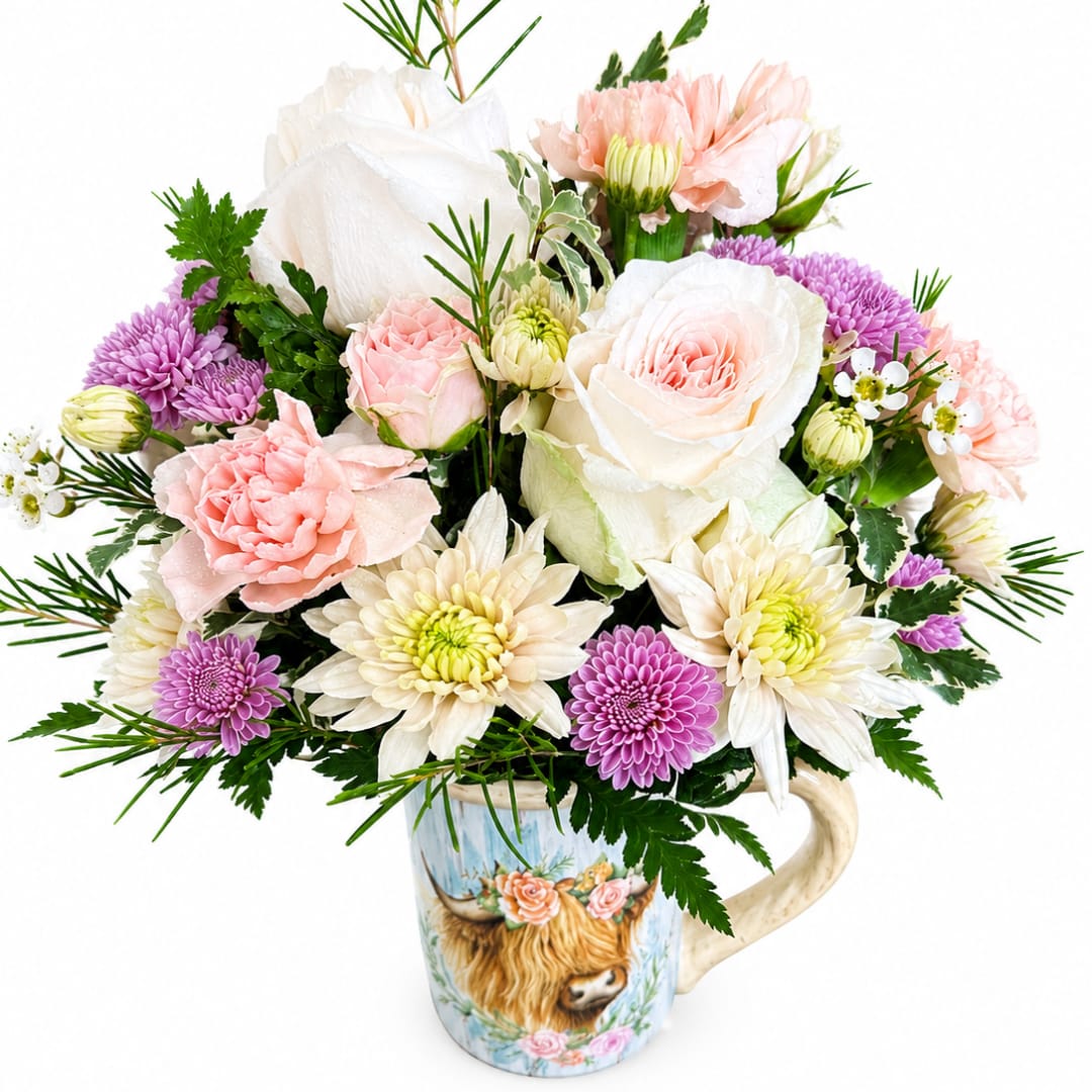 Bouquet of pink, white, and purple flowers in a decorative mug vase