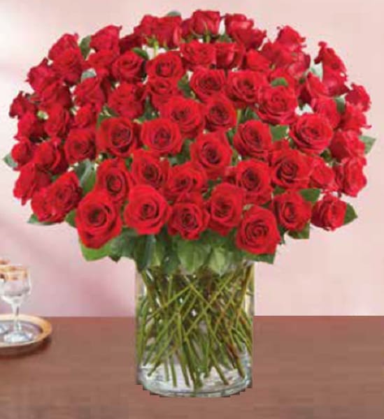 Large bouquet of red roses in a clear glass vase