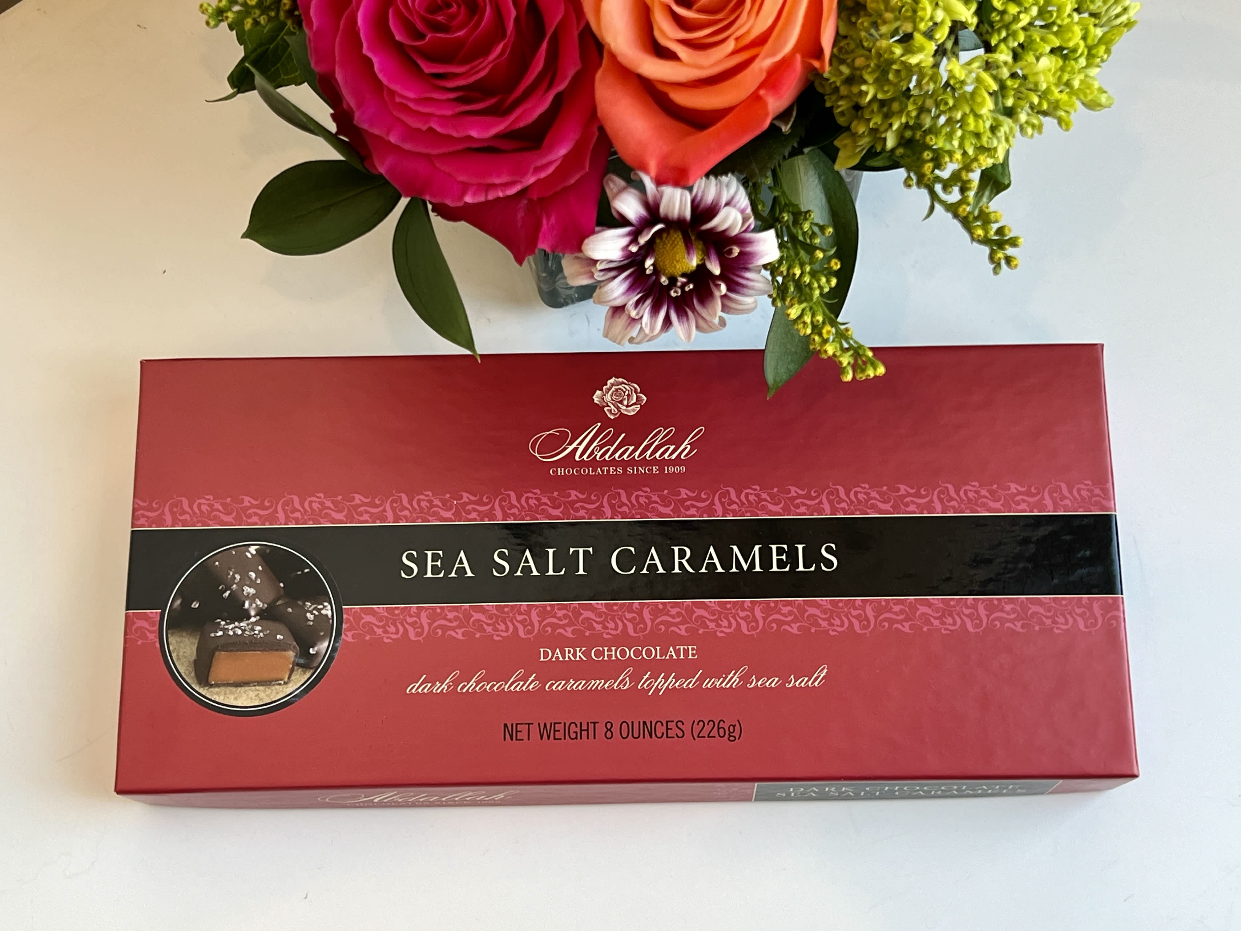 Bouquet above a box of sea salt caramels