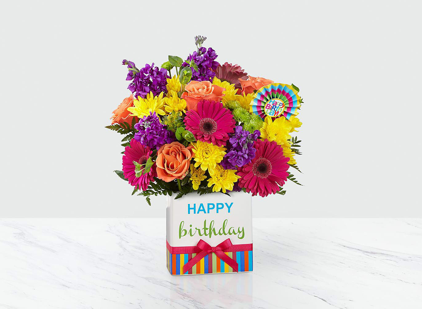 Colorful bouquet in a birthday gift box with a Happy Birthday tag