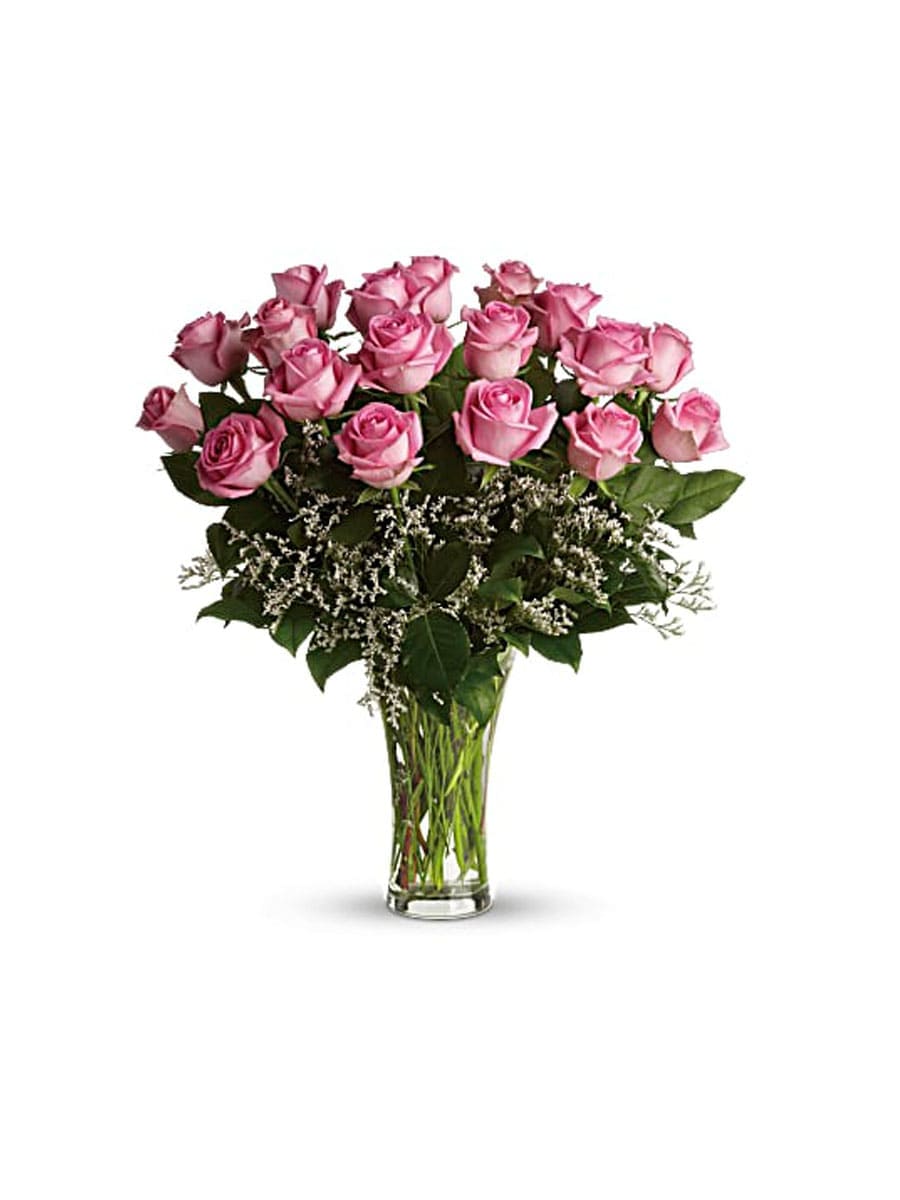 Pink roses arranged in a clear glass vase