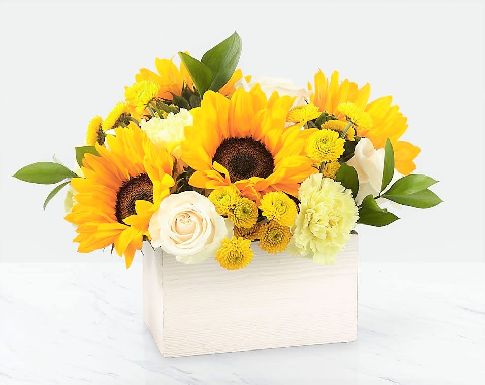 Sunflower and white rose arrangement in a white box