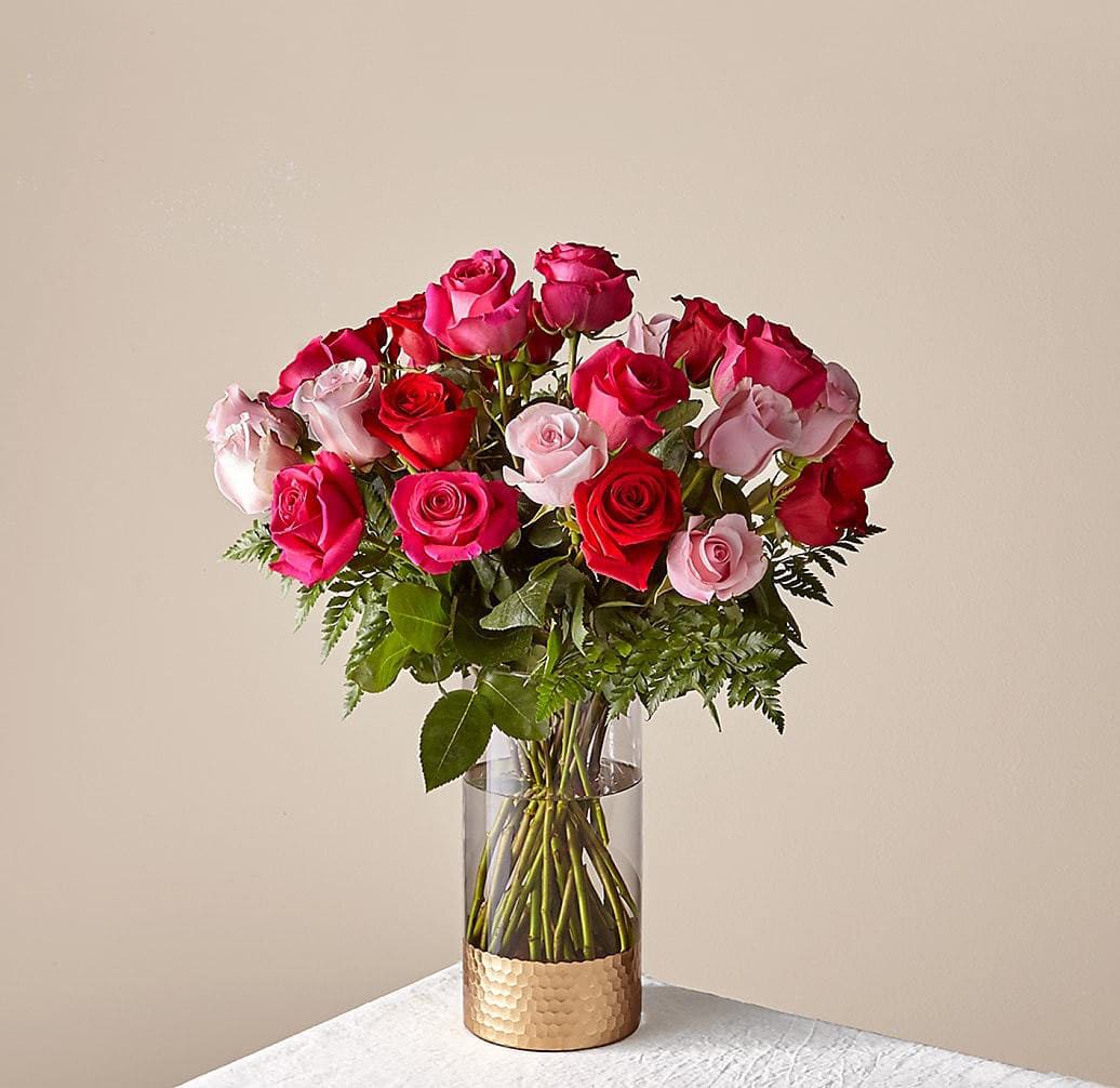 Bouquet of pink and red roses in a clear glass vase
