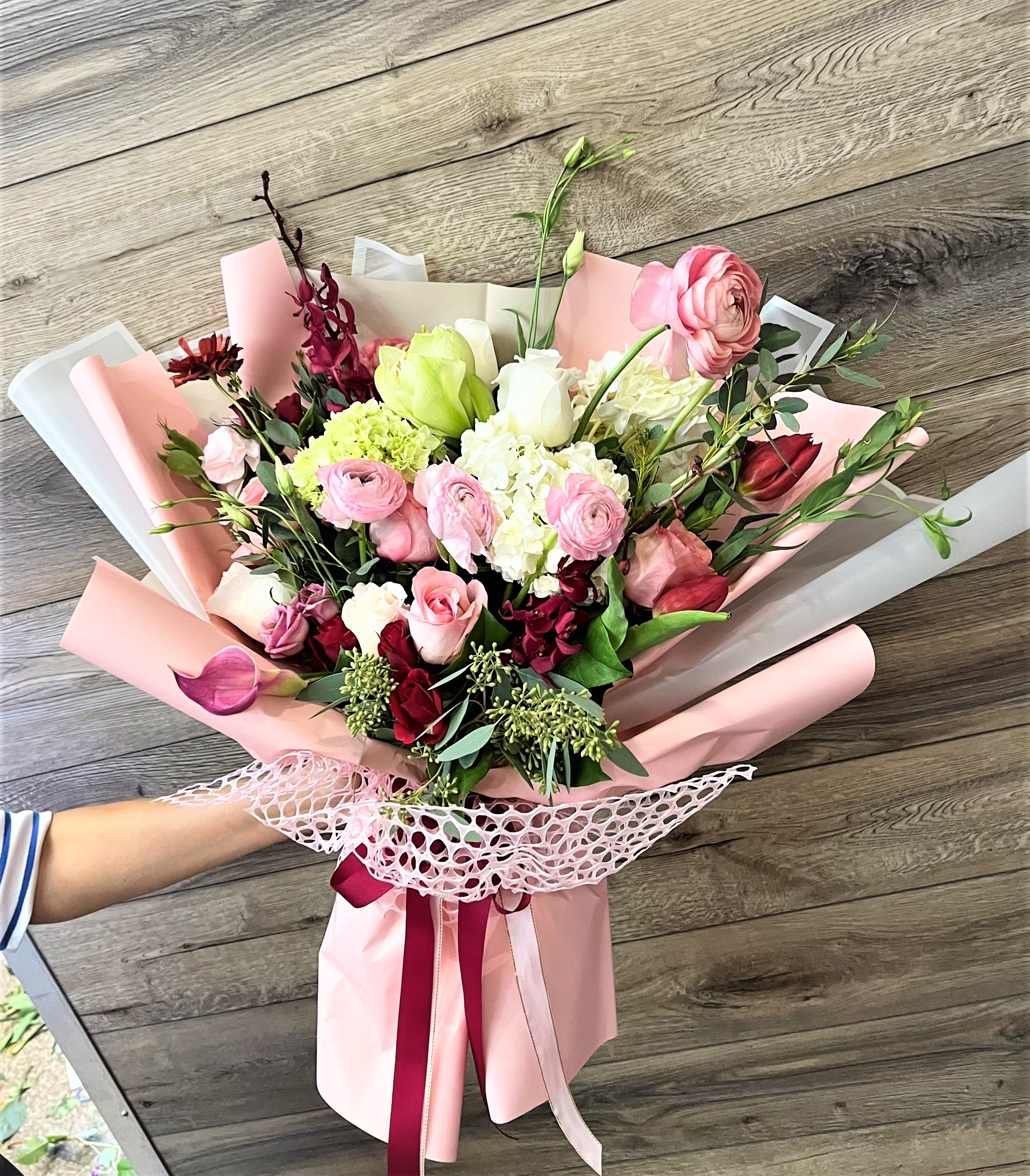 Pink and white mixed bouquet wrapped in pastel paper