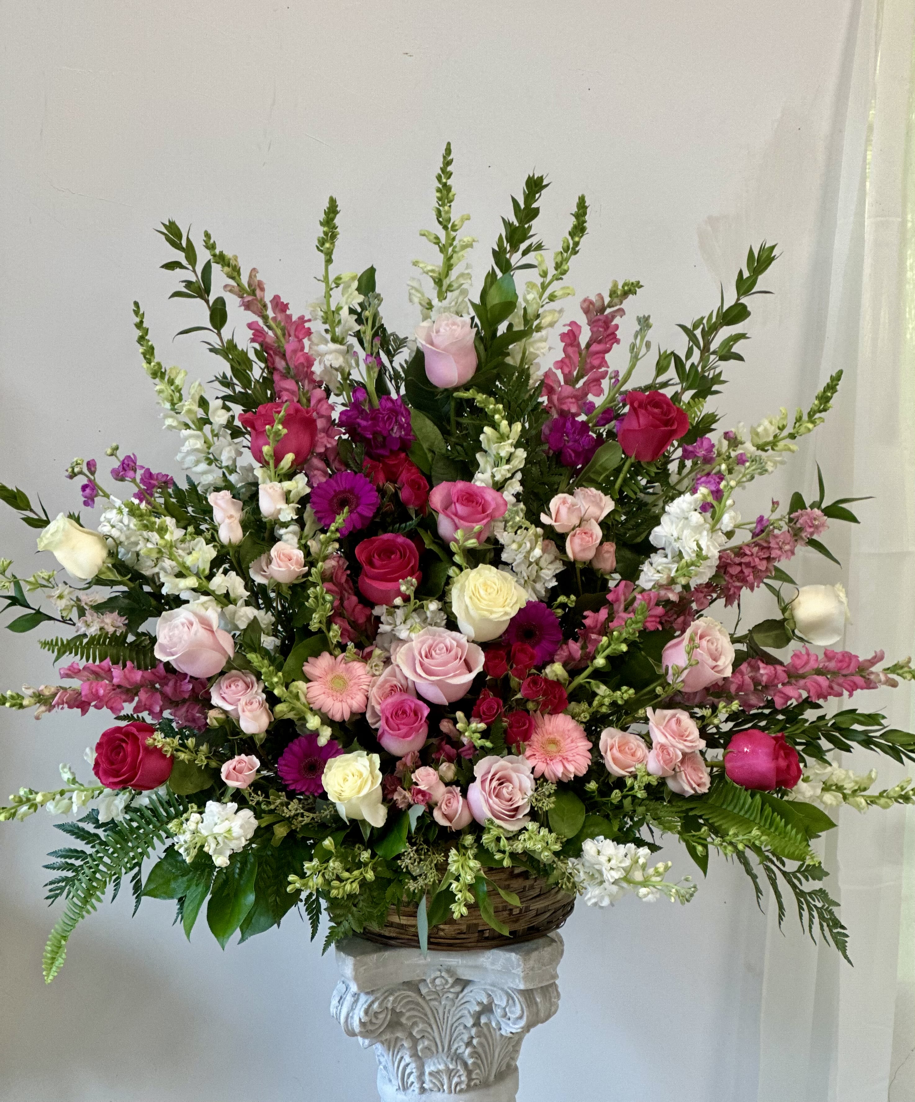 Large basket arrangement of pink, white, and magenta flowers
