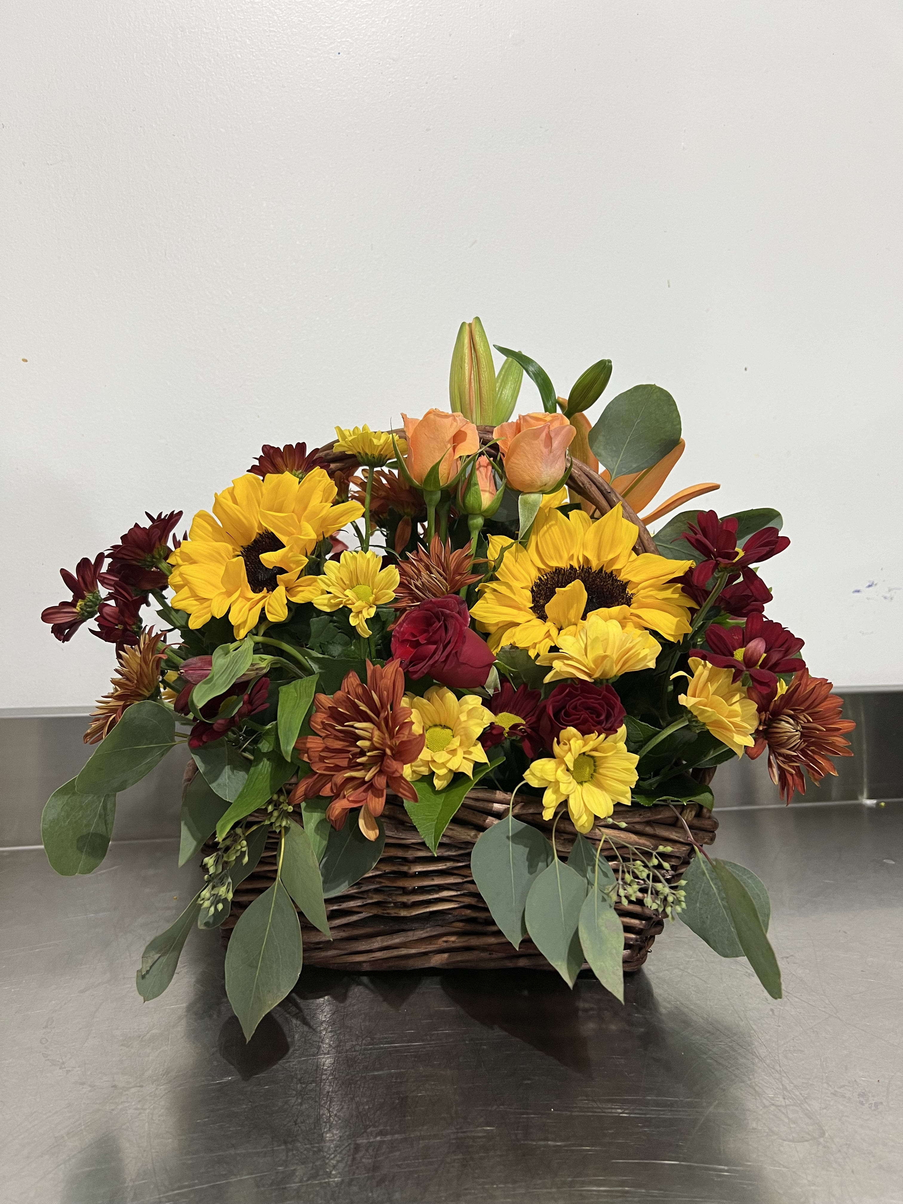 Thankful  - Gorgeous shades of fall. Sunflowers, lilies, spray roses, and assorted daisy poms. This arrangement is perfect for the table on Thanksgiving Day or just to remind someone that you love them, or both. 