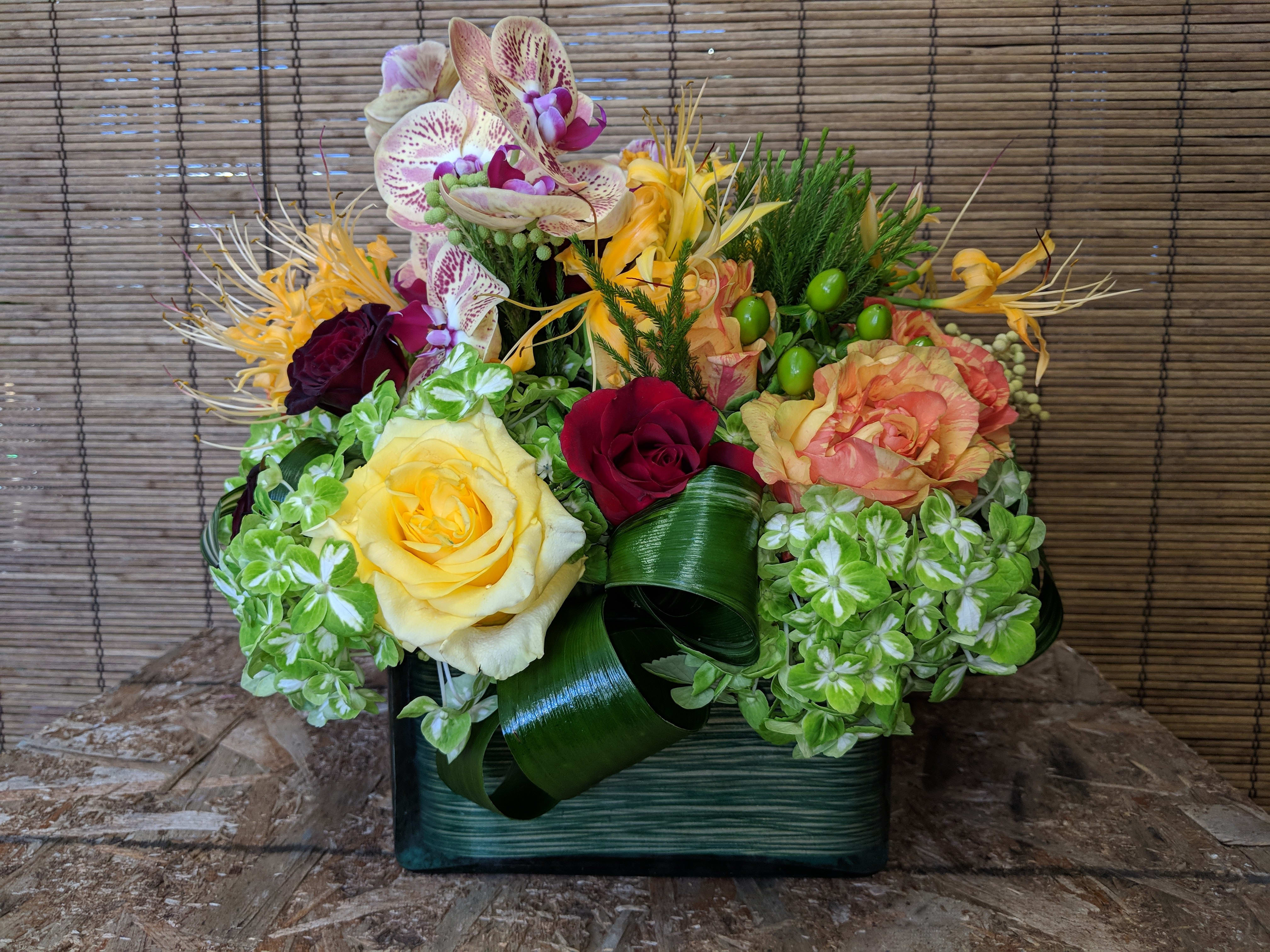 Flying Orchids 1  2 DAY NOTICE - Specialty Orchids grace this contemporary bouquet of Roses, Hydrangeas,  Nerine Lilies, etc. Our designs are all , One of a kind. We will select the best and freshest flowers to design a one of a kind for you, keeping this same contemporary  look.