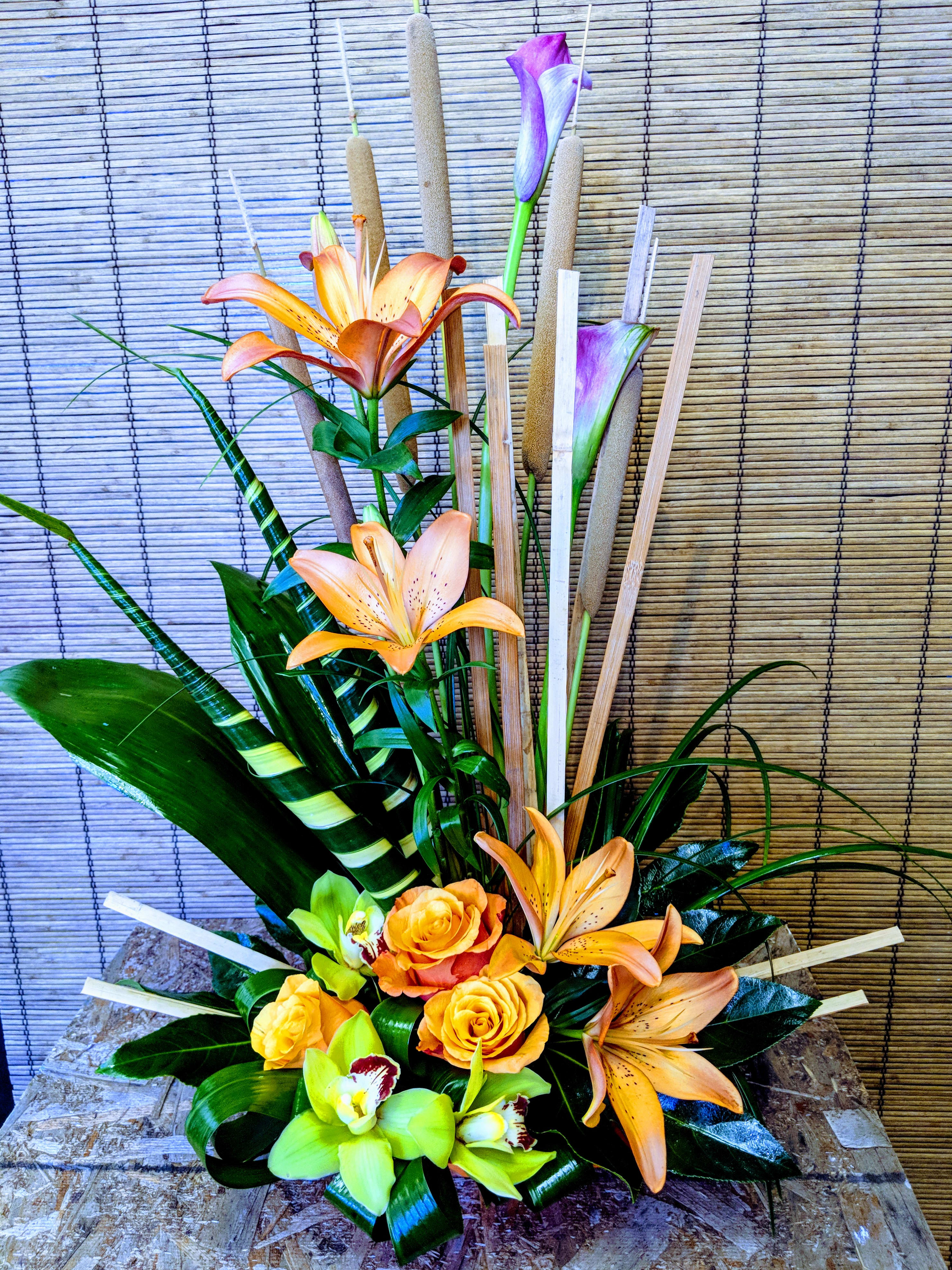 Paradise Found by VNF - Orange Lilies, Green Cymbidium Orchids, Calla Lilies, etc. make a grand impression and bring the tropics too !