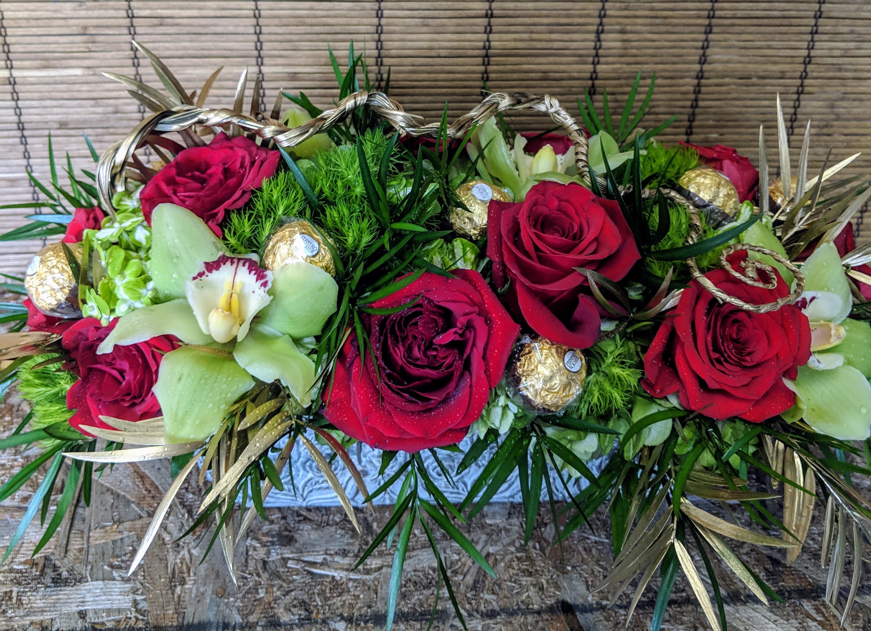 Exclusive Yuletide Greetings by VNF - Wooden Box with  Red Roses, Green Cymbidium Orchids, etc, accented with Gold Leaves and Gold Designer Rope. Perfect for the dinner table or coffee table