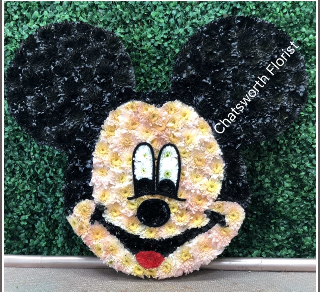 Mickey Mouse face floral display with black ears and pastel flowers