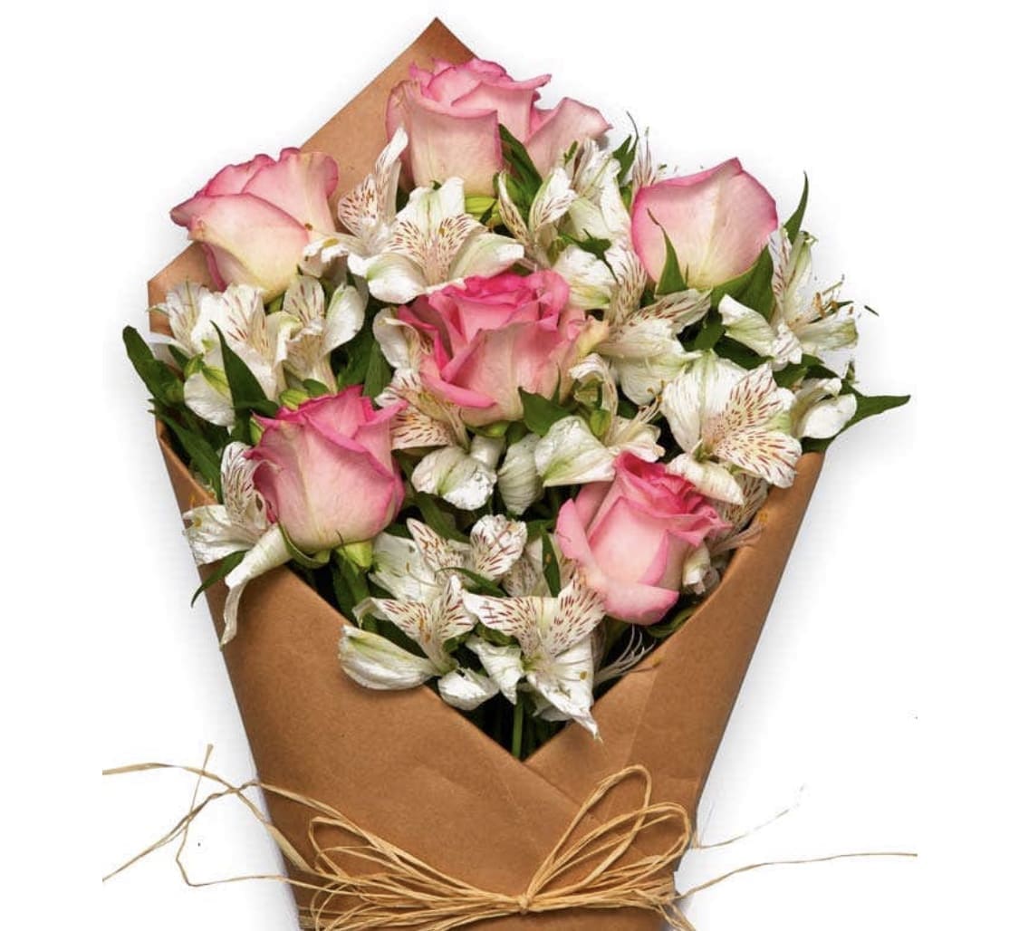Bouquet of pink roses and white alstroemeria wrapped in brown paper