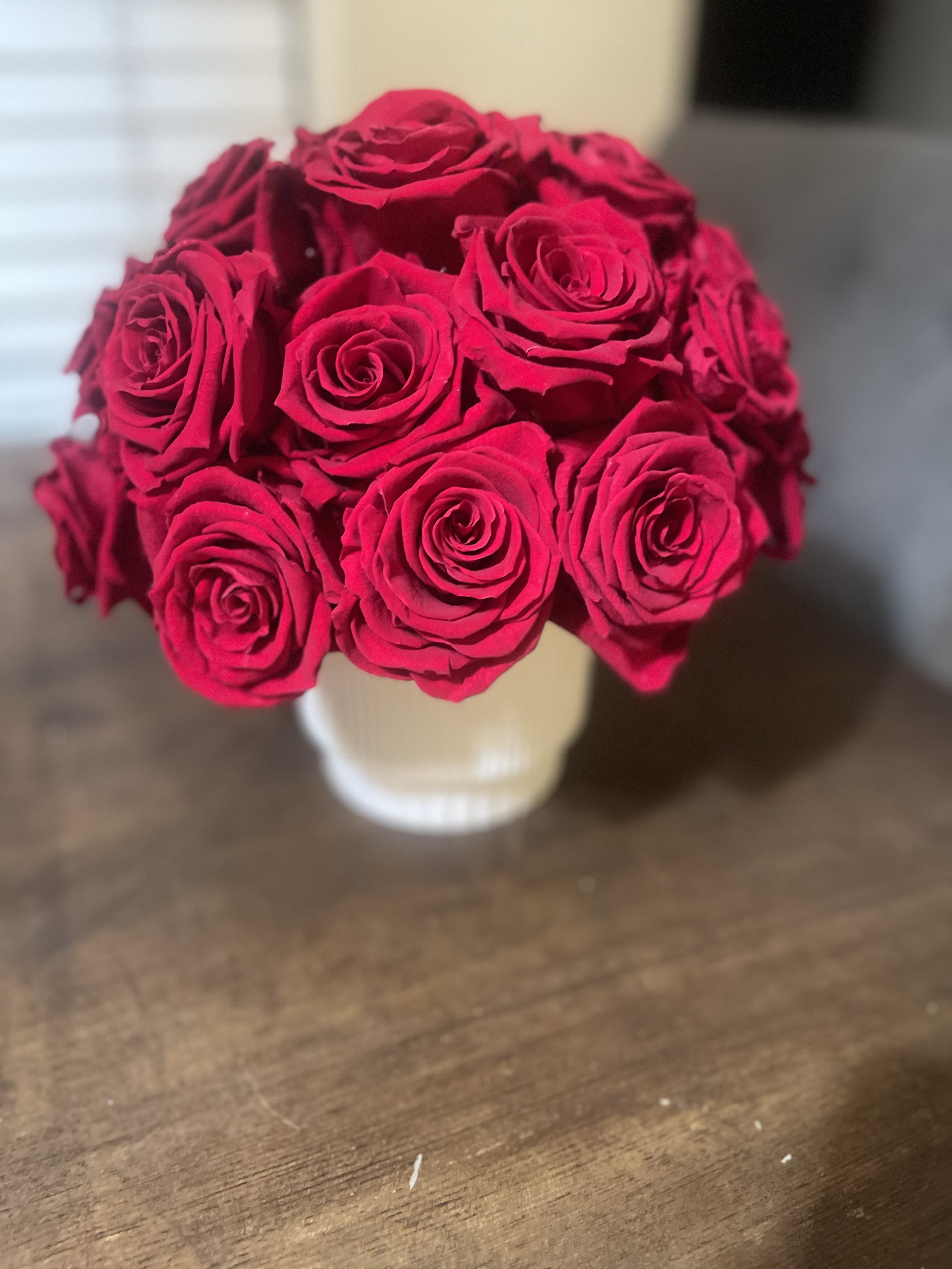 Bouquet of bright red roses in a white vase