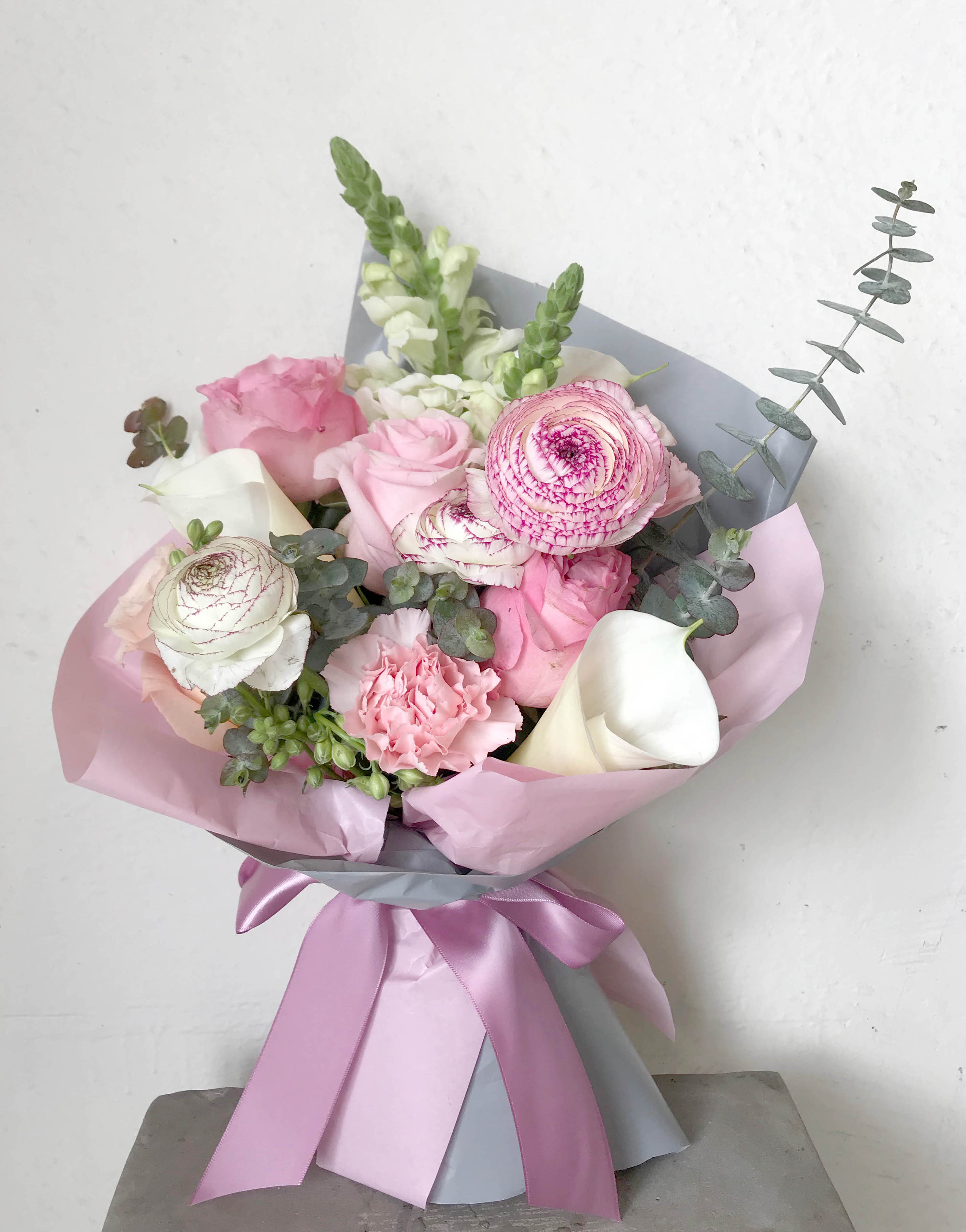 Pink and white bouquet with roses, ranunculus, calla lilies, and snapdragons