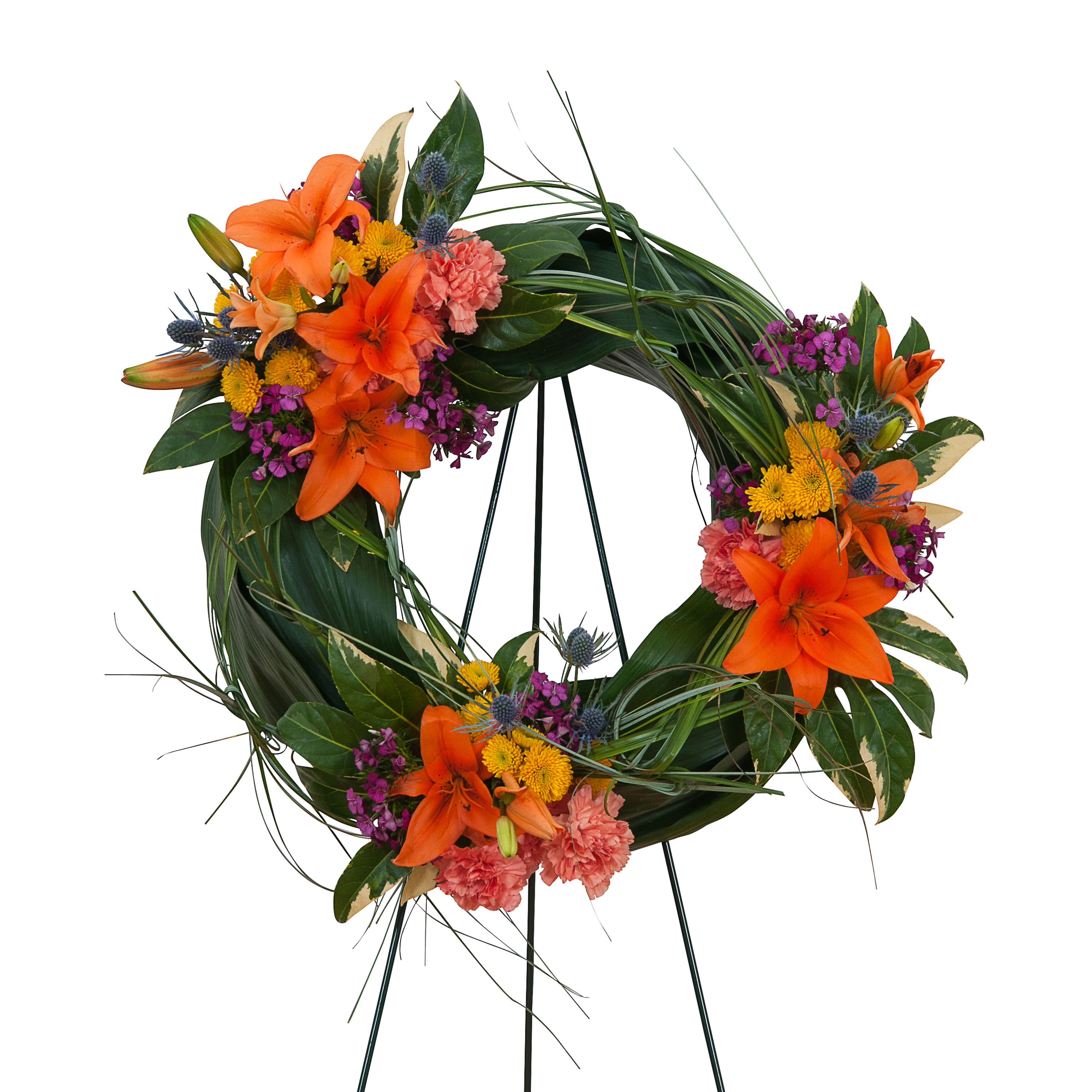 Circular floral wreath with orange lilies and pink carnations