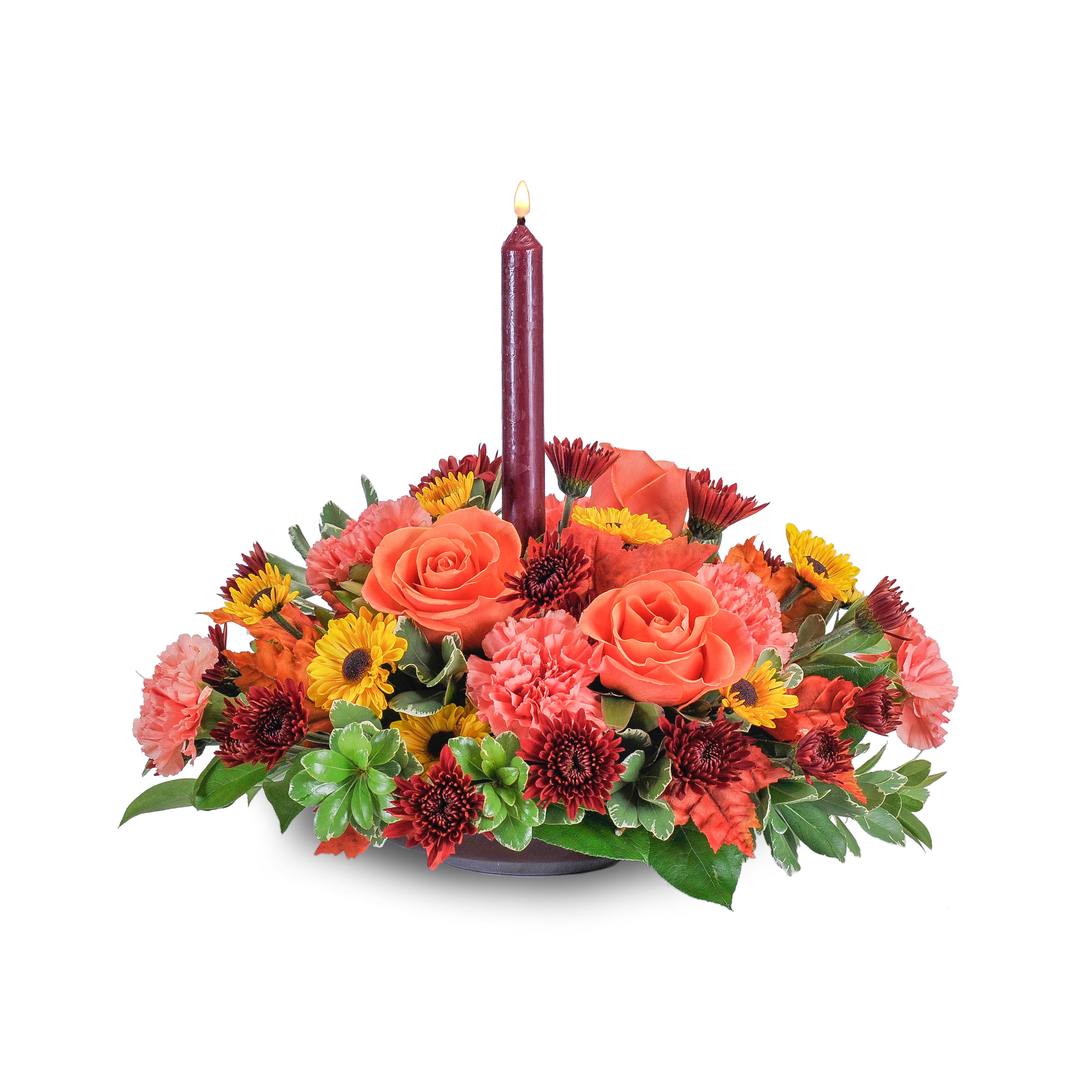 Pumpkin Glow - This beautiful selection of fall color flowers with the warm glow of a candle will prepare your table for your special celebration. You just need the pumpkin pie! Orange roses and carnations, spray mums and fall color leaves surround a taper candle.