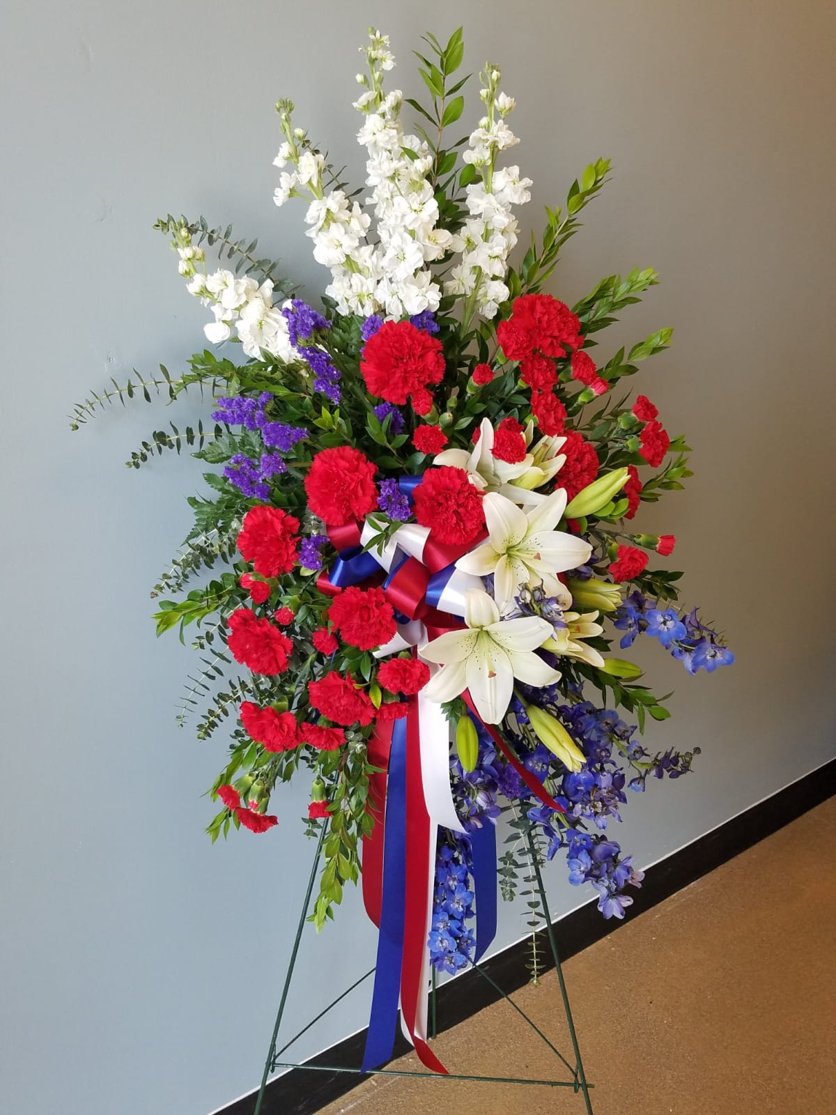 Tribute standing spray - Red white blue standing spray