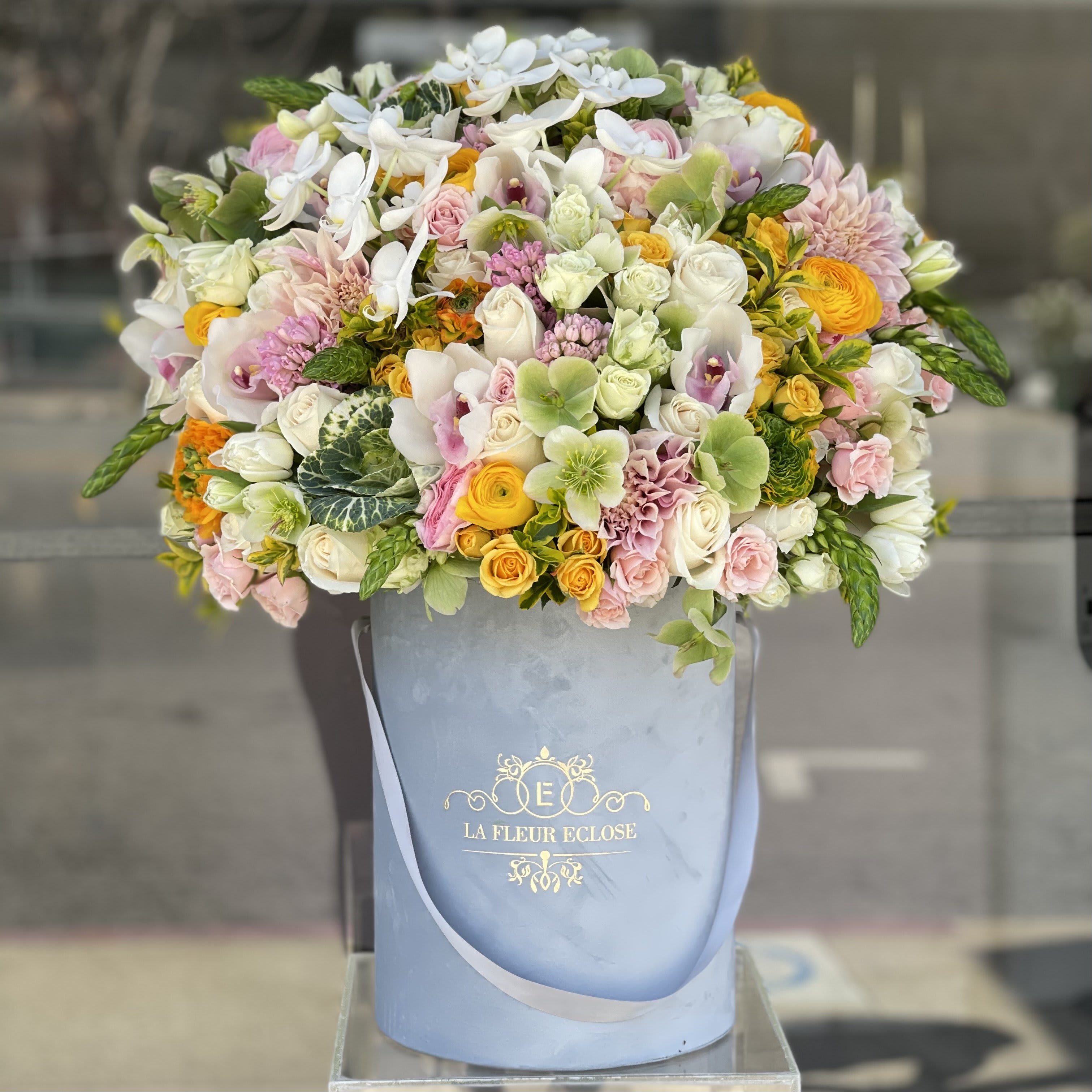 Large pastel bouquet in a blue hatbox with white and pink flowers