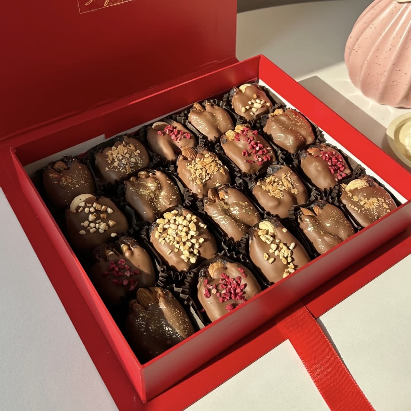 Box of chocolate-covered dates in a red gift box