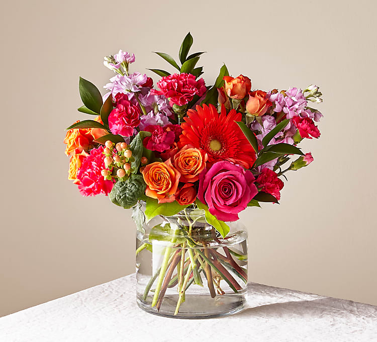 Fiesta Bouquet - Vibrant flowers create a lively, colorful mix for any celebration, presented in a clear vase.