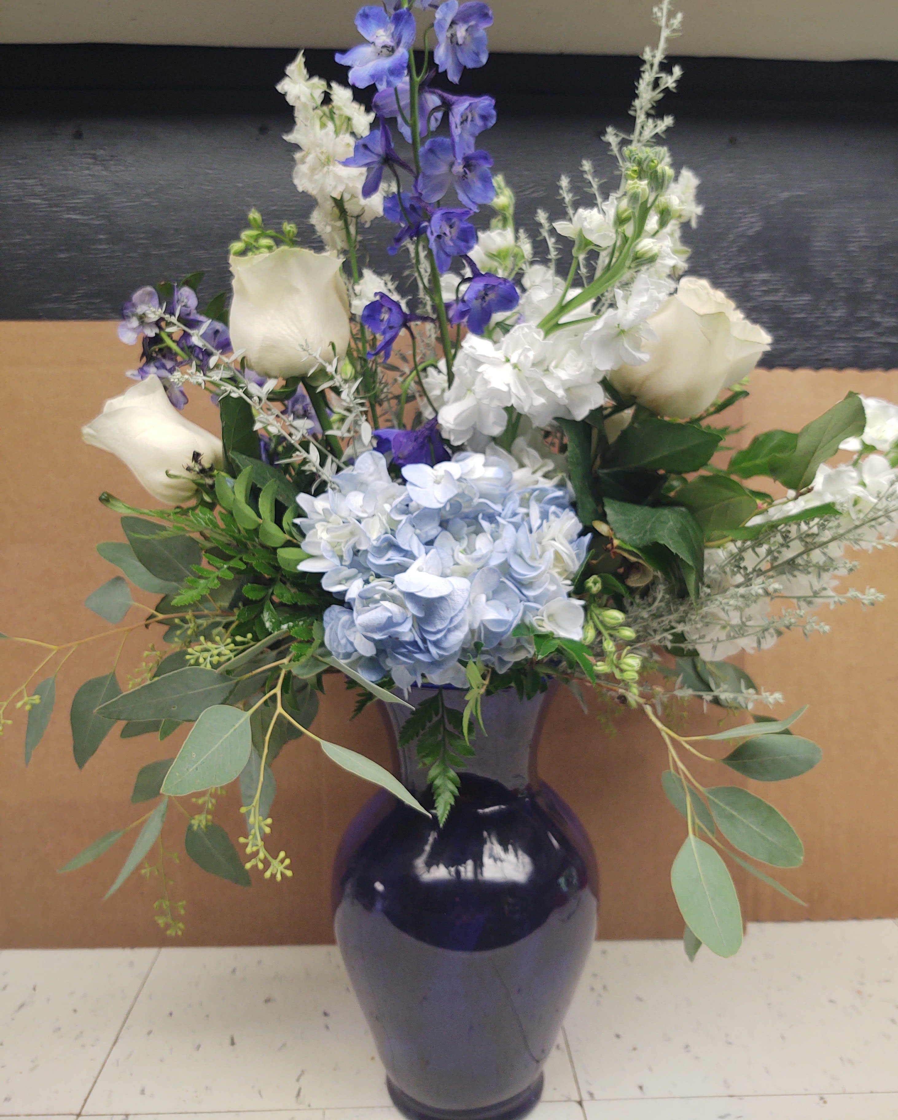 Blue Vase with blue & white flowers in Midland, MI