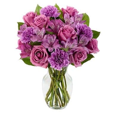 Pink and purple bouquet in a clear glass vase