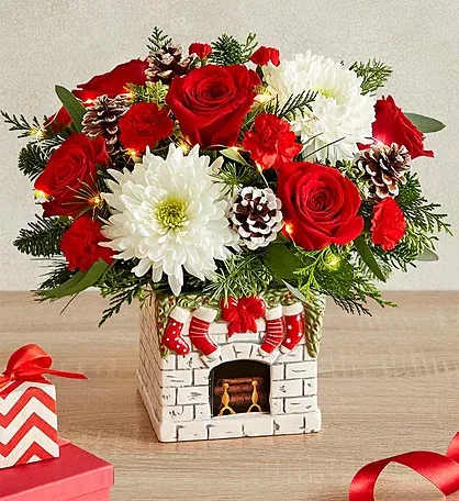 Christmas bouquet with red roses and white chrysanthemums in a decorative vase