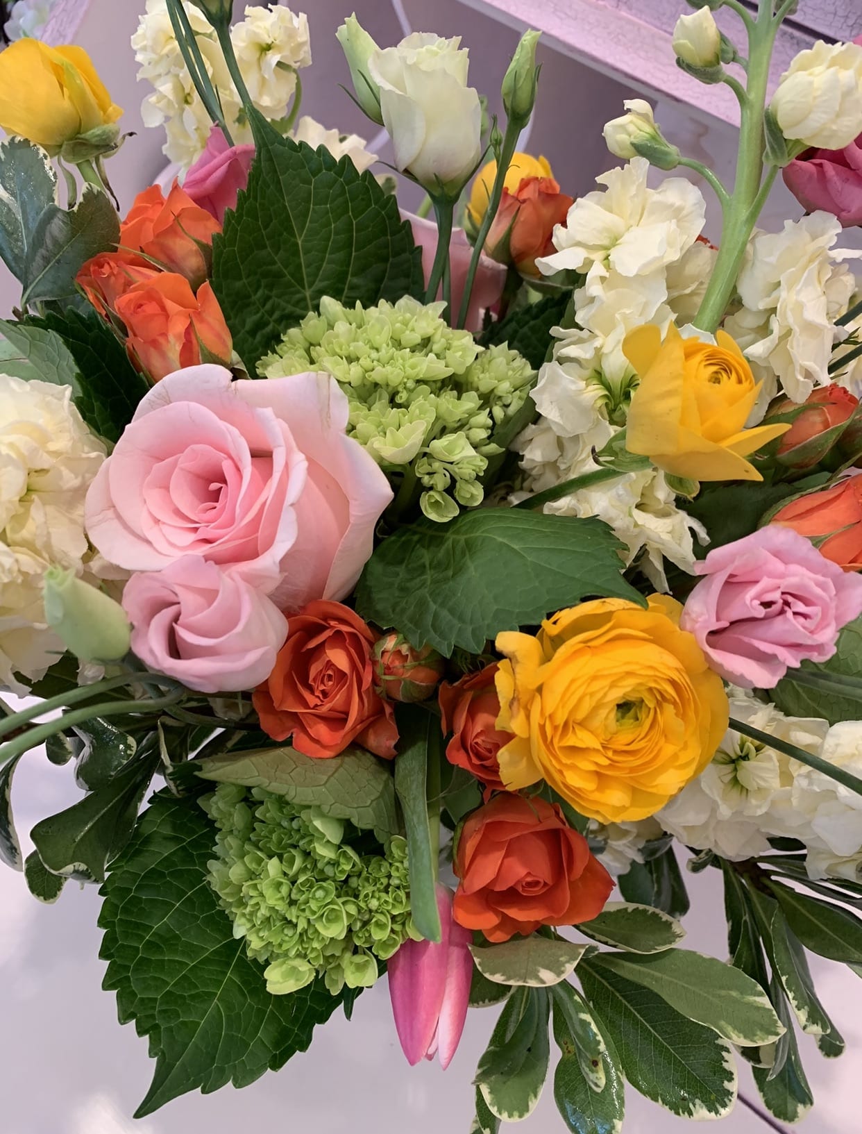 Just Because  -  This bouquet will put a smile on anyone’s face for that special occasion.  Featuring roses tulips and ranunculus from the Holland region.  