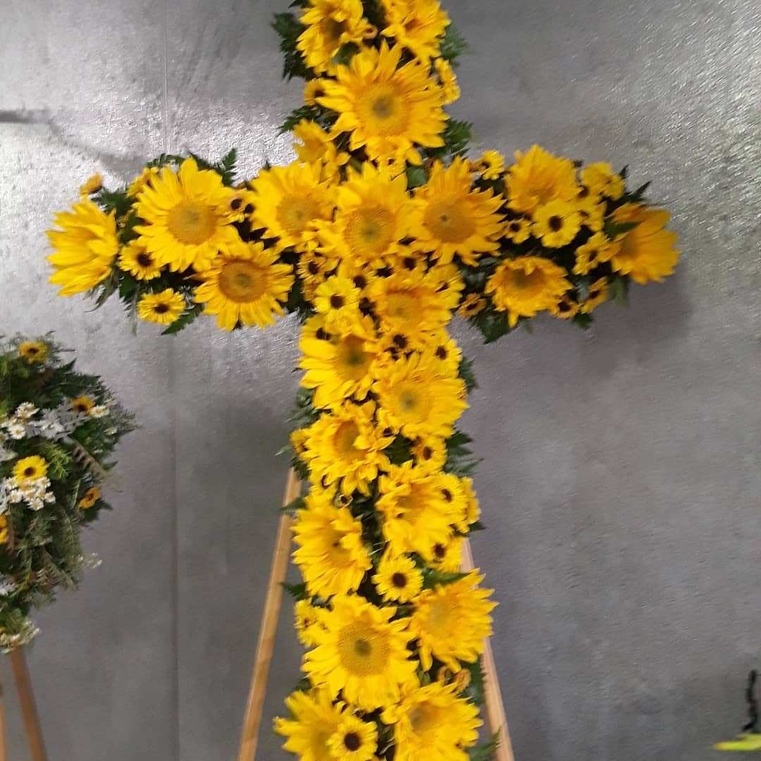 Yellow sunflower cross on a stand