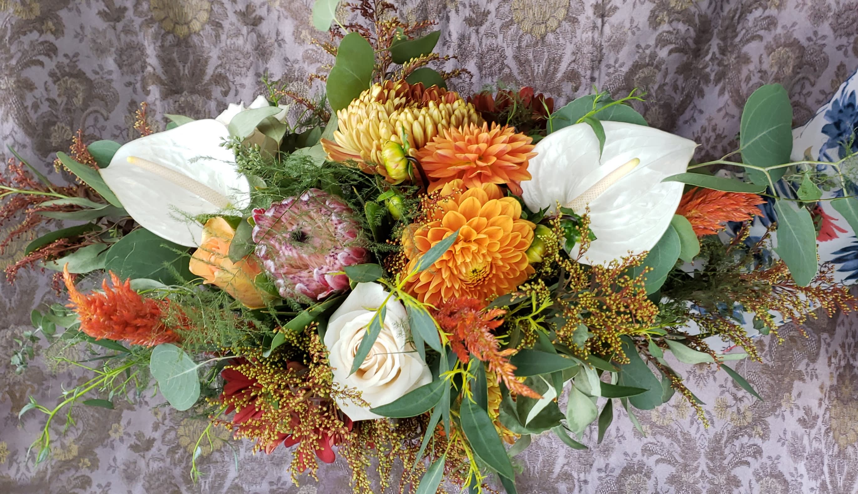 Mixed bouquet with white calla lilies and orange dahlias