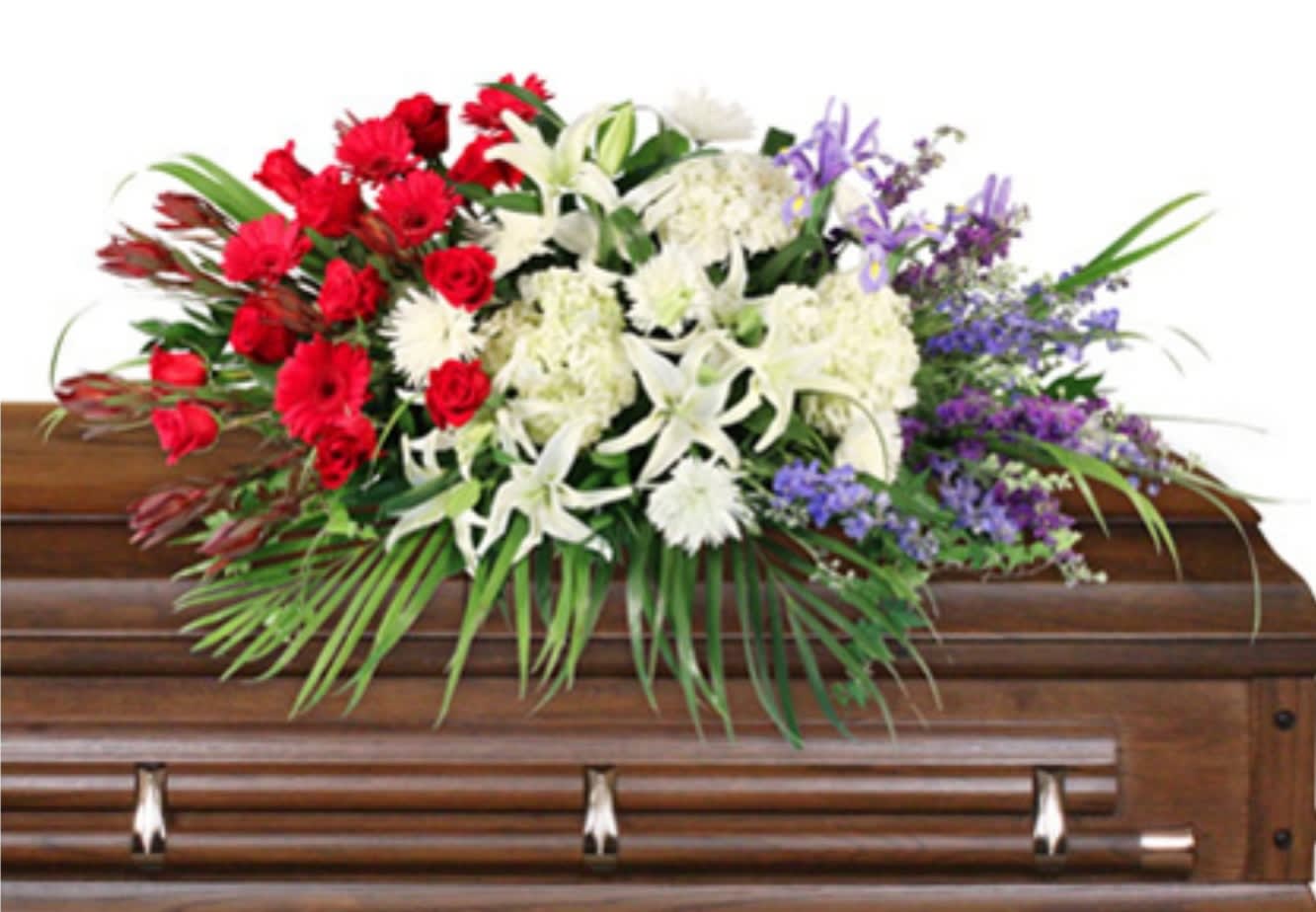 Casket spray with red, white, and purple flowers