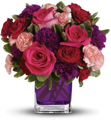 Pink and red roses with purple carnations in a purple glass vase