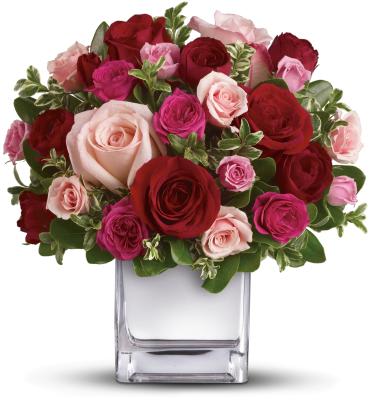 Bouquet of red and pink roses in a clear square vase