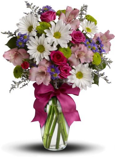 Mixed bouquet of daisies, roses, and pink lilies in a glass vase