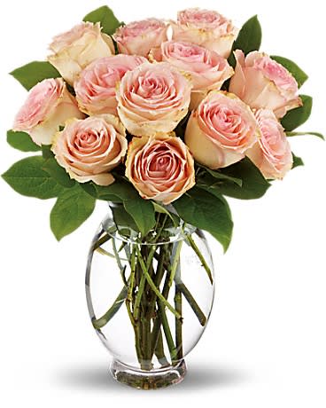 Pink roses arranged in a clear glass vase