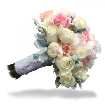 Bouquet of pale pink and white roses with blue-gray foliage