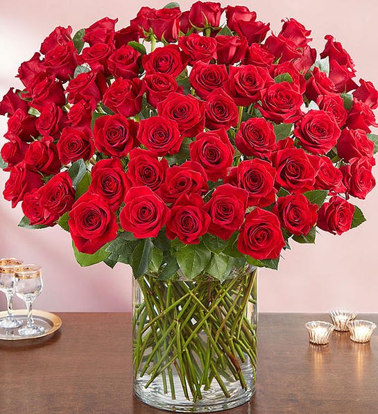 Large bouquet of red roses in a clear glass vase
