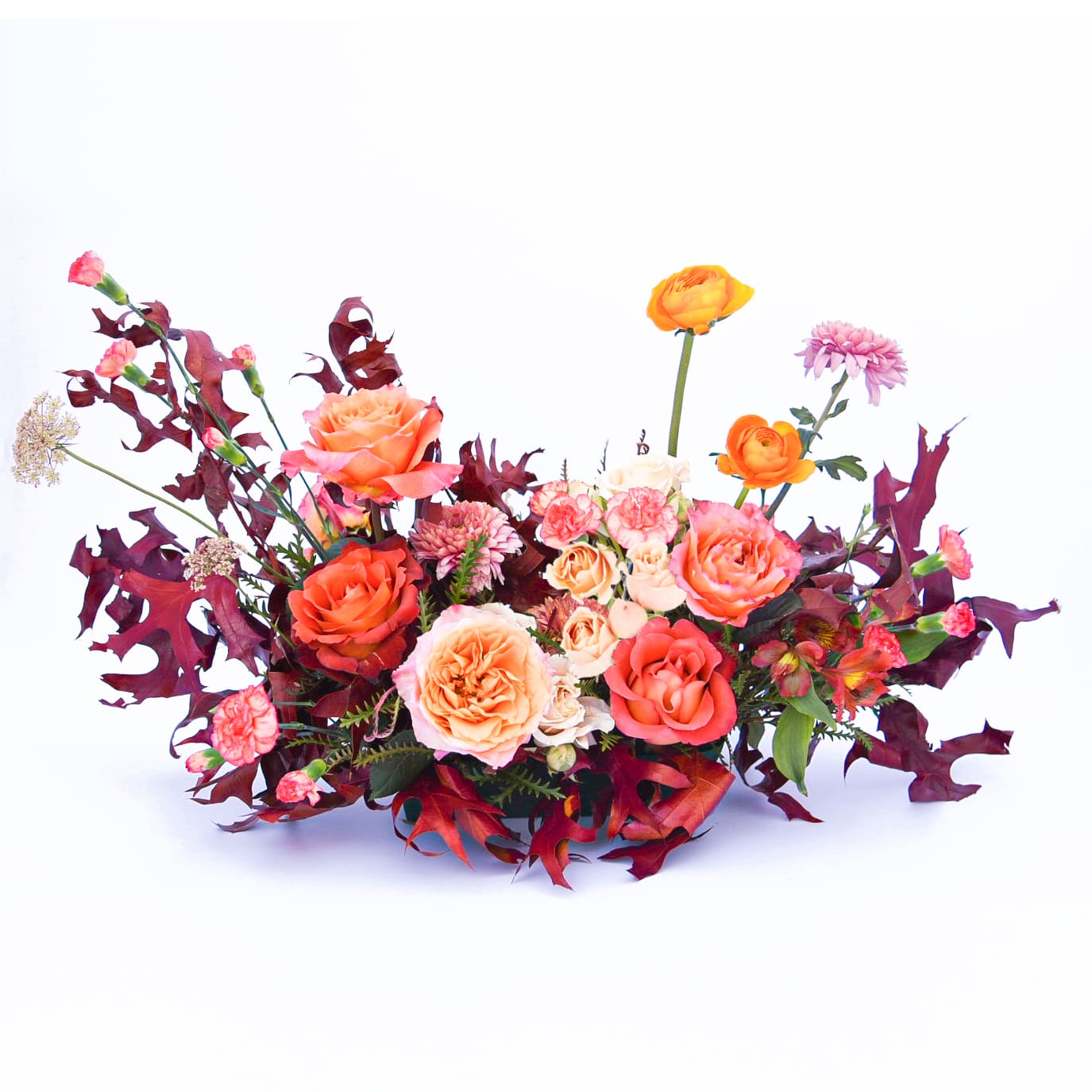 Autumn Embers Centerpiece - Bright orange tones pop in a nest of burgundy and rust. This style evokes the warmth of a blazing bonfire on a crisp fall night.  Approximate size is 24" x 16"