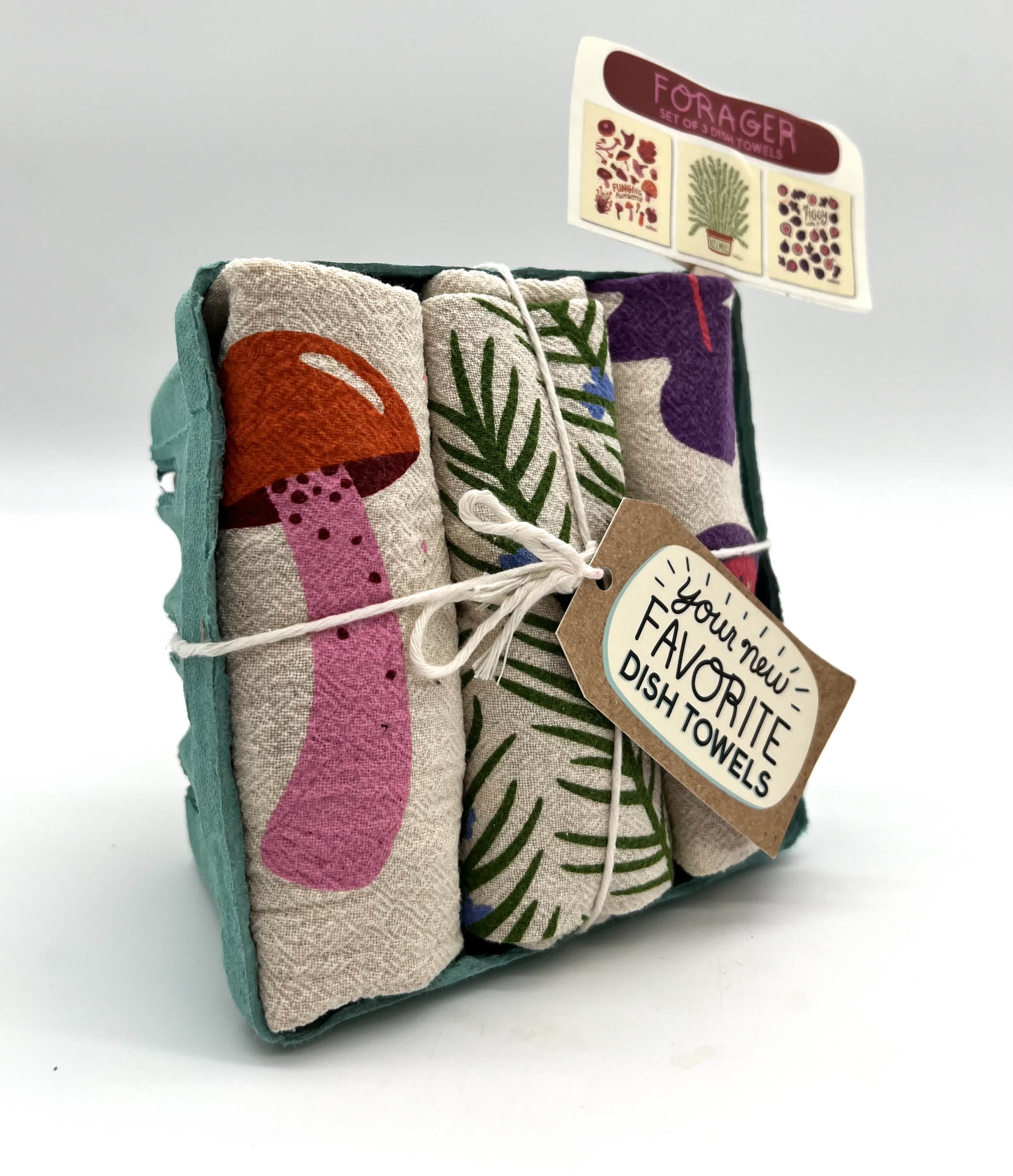 Set of three printed dish towels in a teal tray with mushroom and foliage designs
