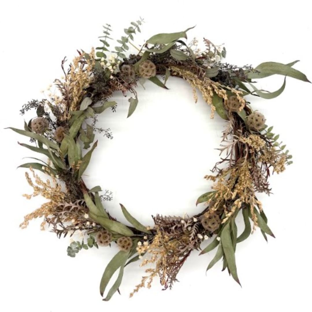 Dried floral wreath with muted green leaves and tan seed pods