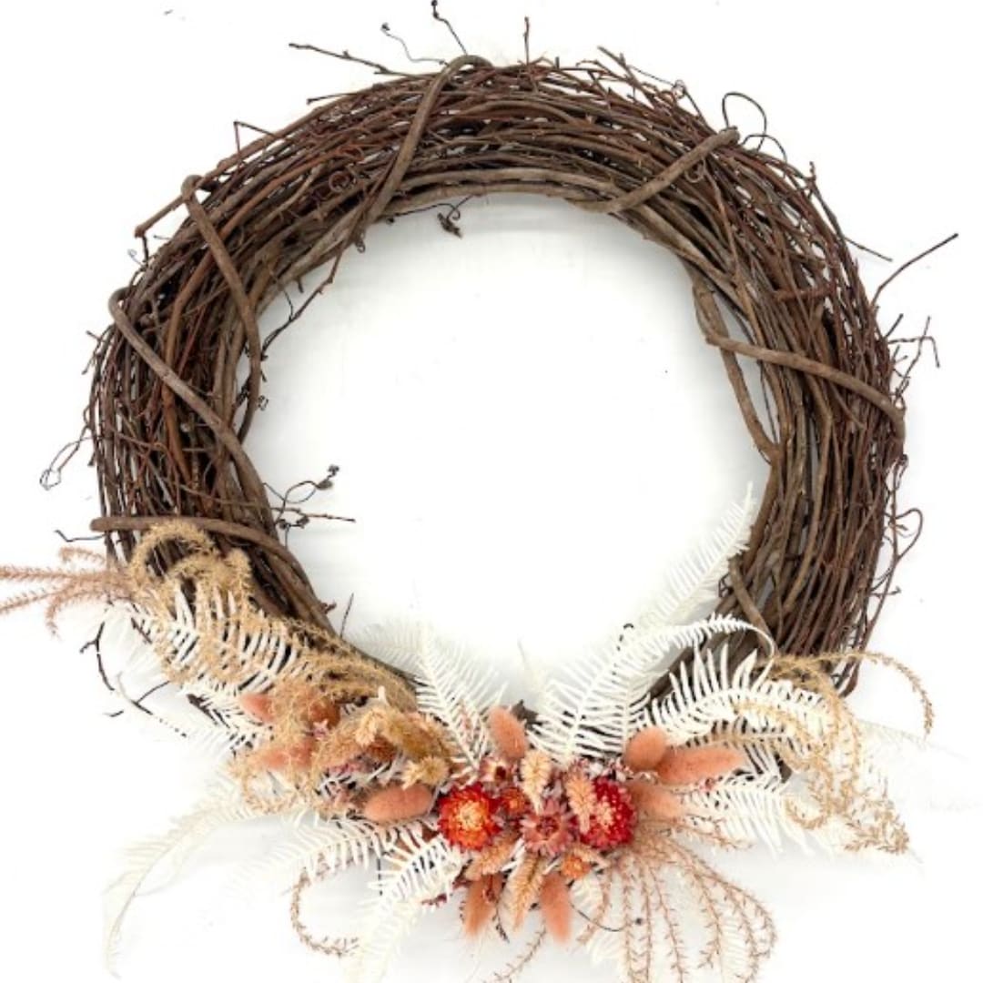 Rustic grapevine wreath with dried flowers and pale fern accents