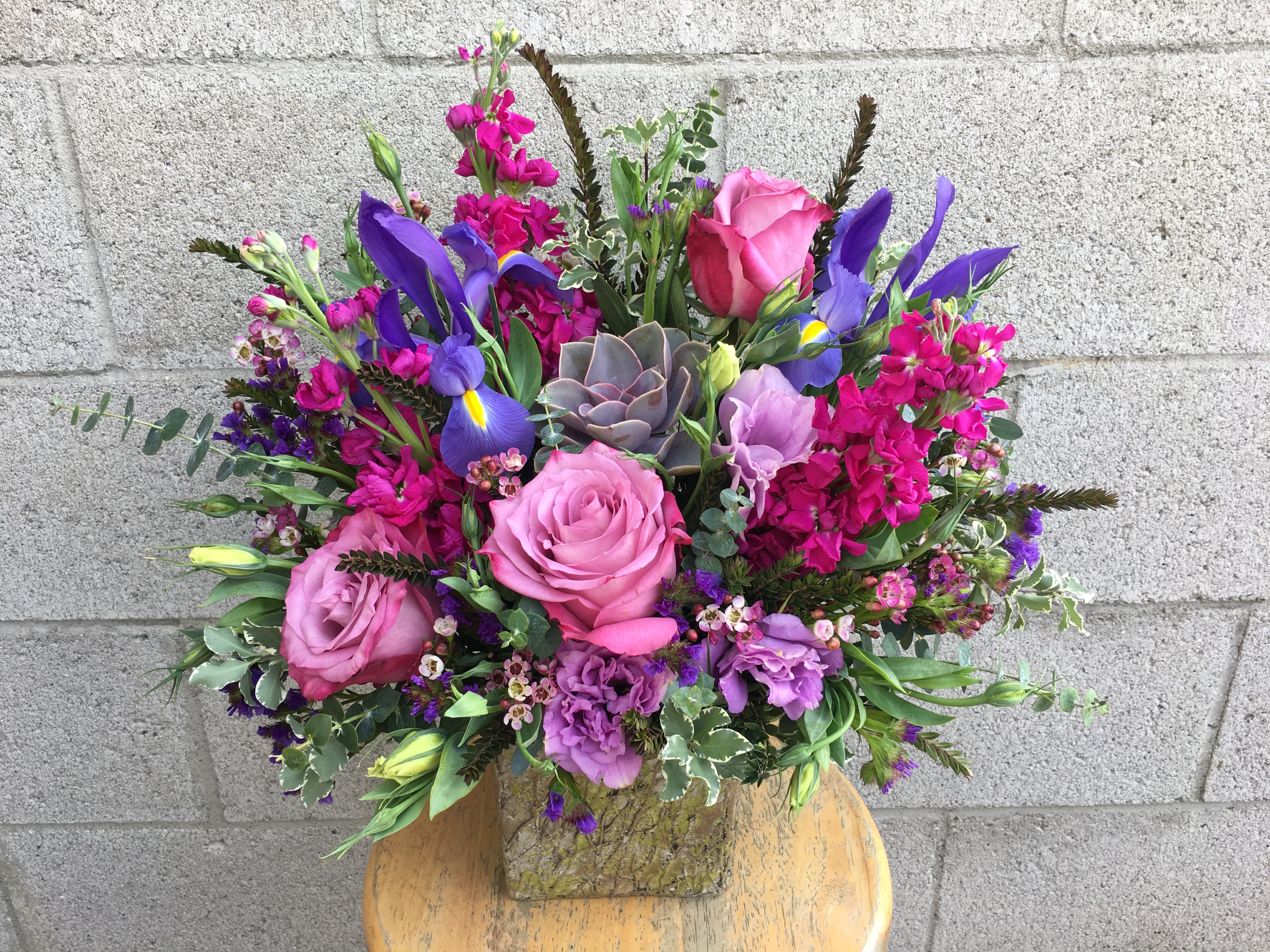 Graceful Garden - Roses, lisianthus and a succulent in shades of lavender among fuchsia stock and blue iris.   