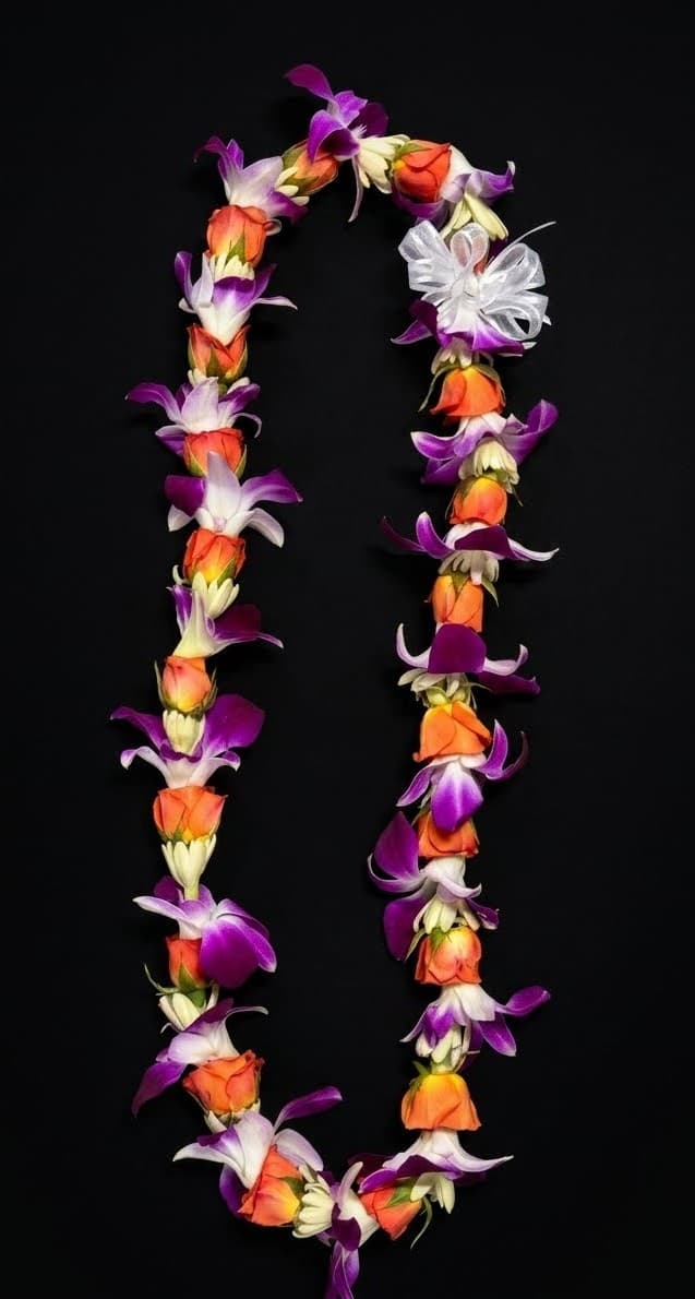 A floral lei made of orange, purple, and white blossoms on a black background