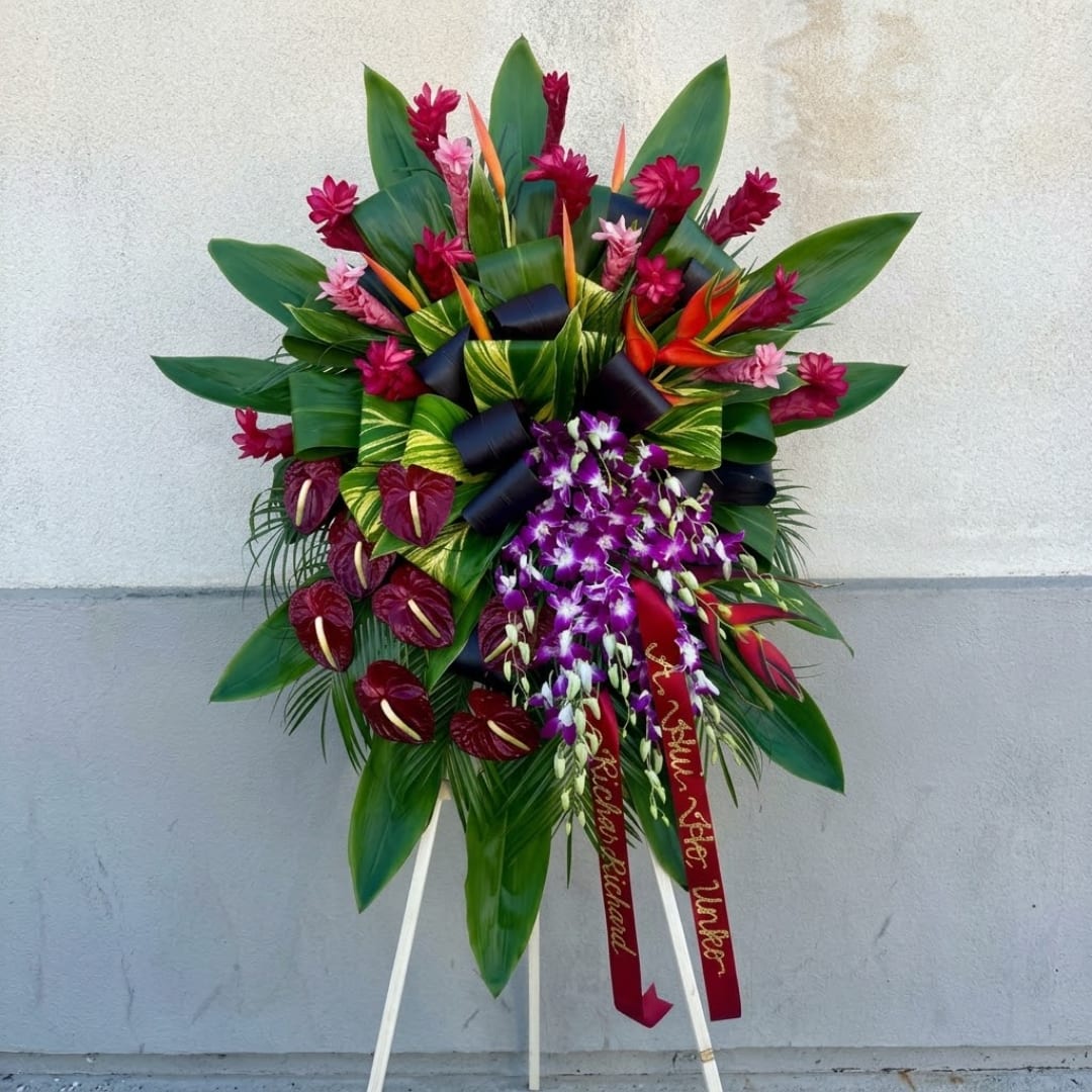 Large tropical floral standing spray with purple orchids and red blooms