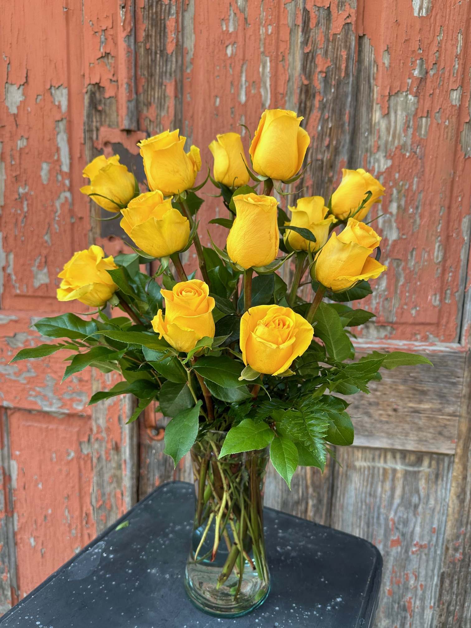 Yellow roses arranged in a clear glass vase