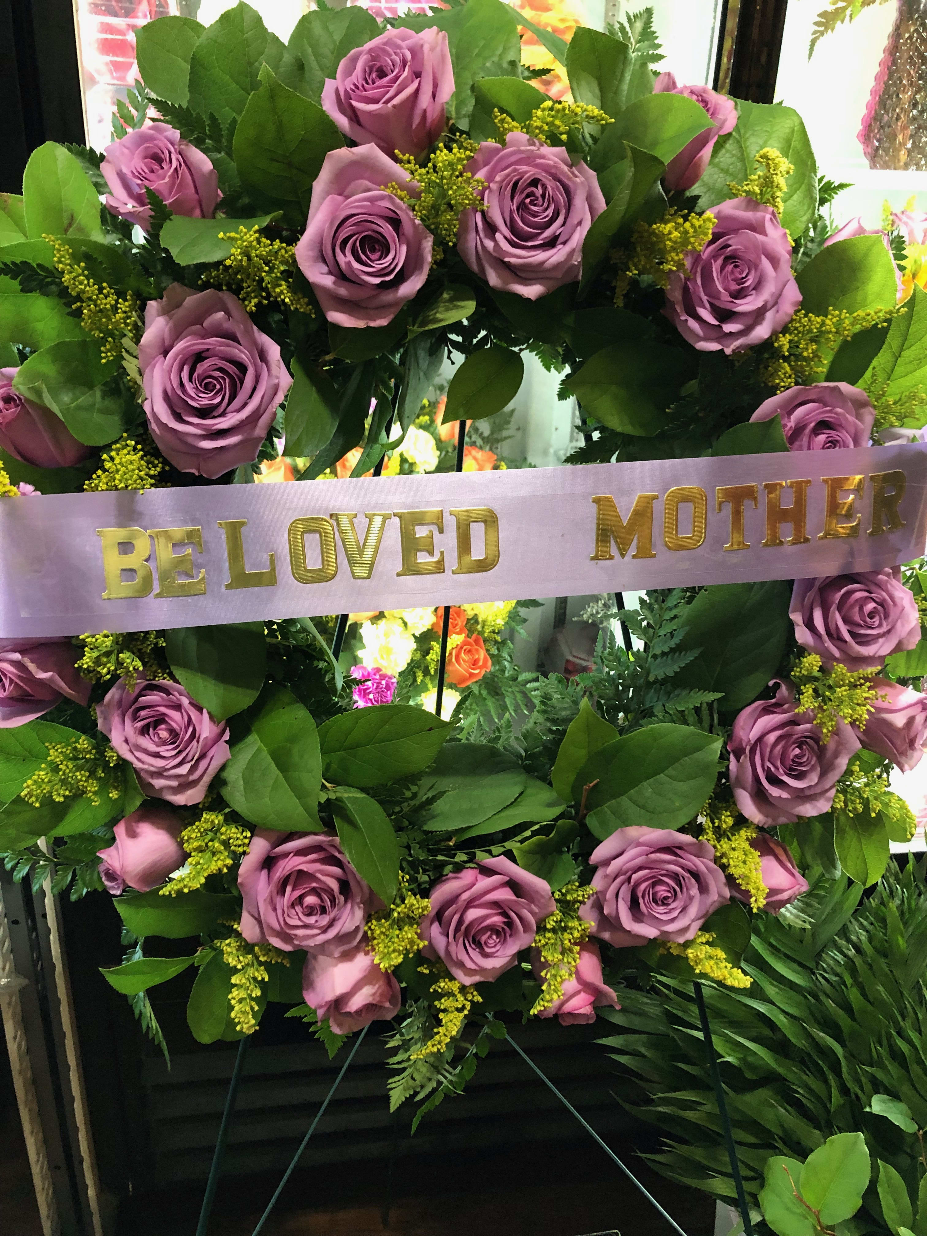 Lavender rose wreath with a "Be Loved Mother" ribbon